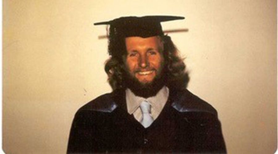 Ian Poiner wearing a graduation hat.