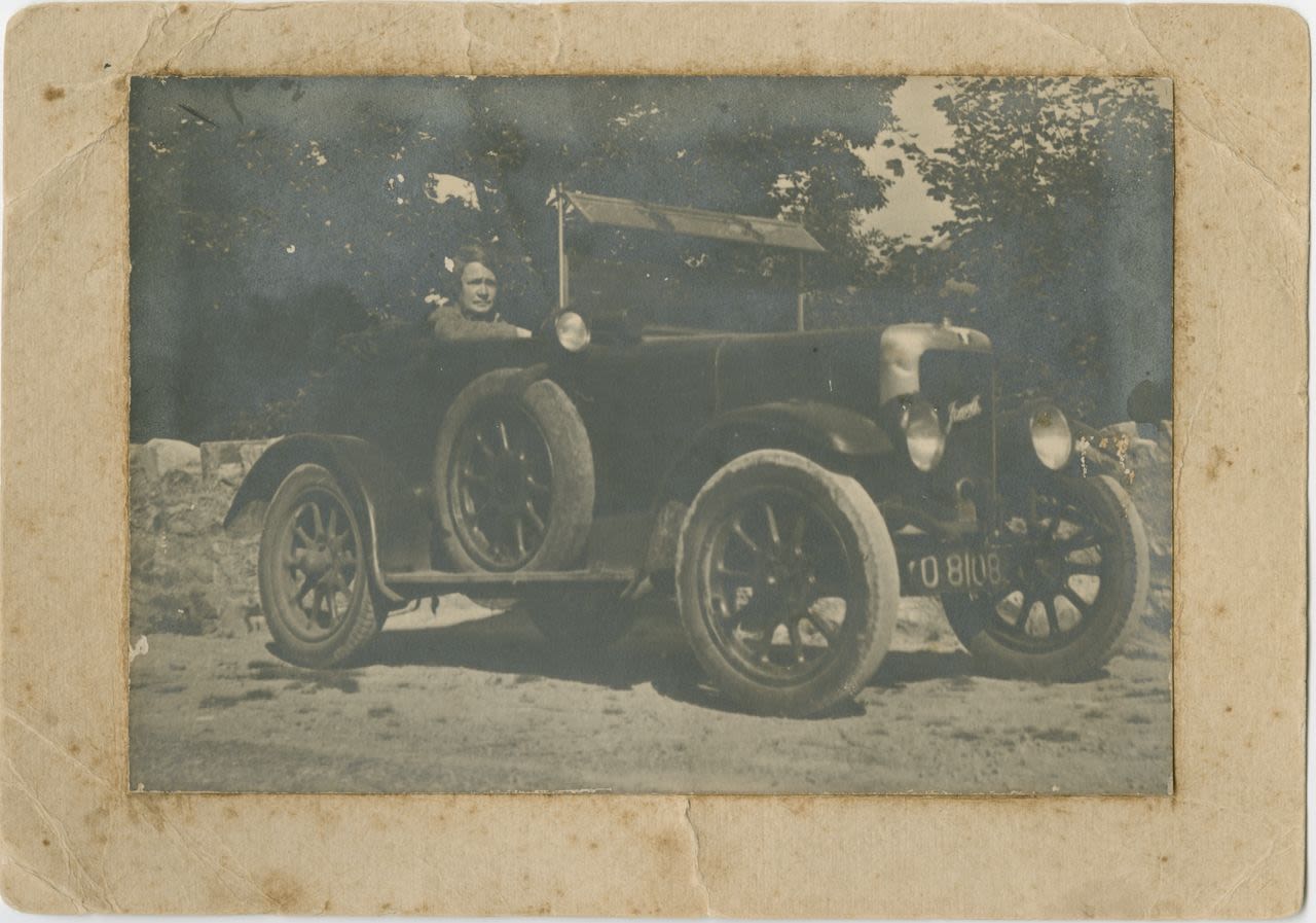 Dorothy Hill driving a car in England in 1932