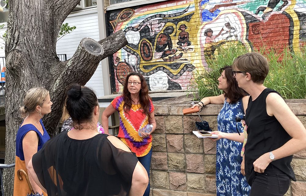 UQ staff outside mural at St Lucia