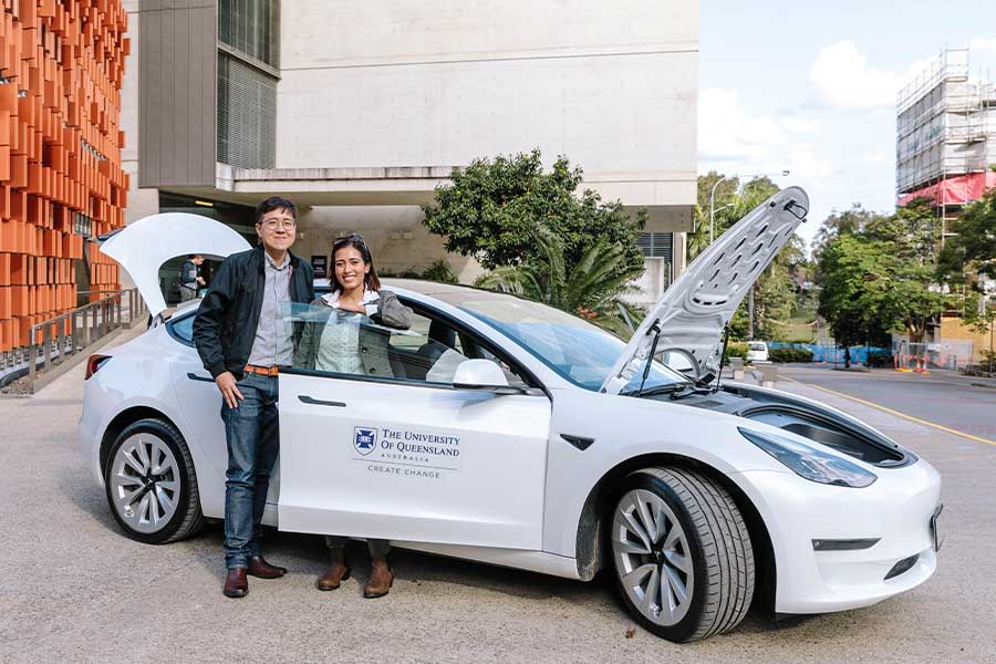 An Dr Kai Li Lim and Dr Dia Adhikari Smith with a Tesla.