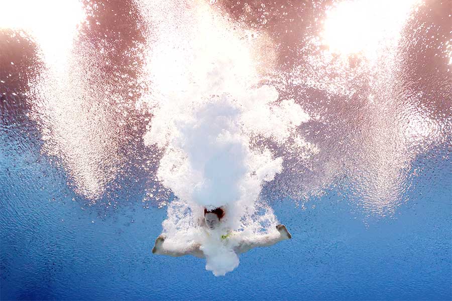 An image of UQ student Emily Meaney under water after a performing a dive during the women's 10-metre platform final.