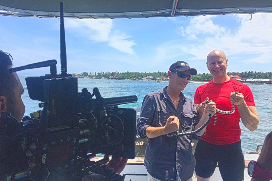An image of Chris Hay with UQ Associate Professor Bryan Fry with a yellow-lipped sea krait off Penida Island, Indonesia.