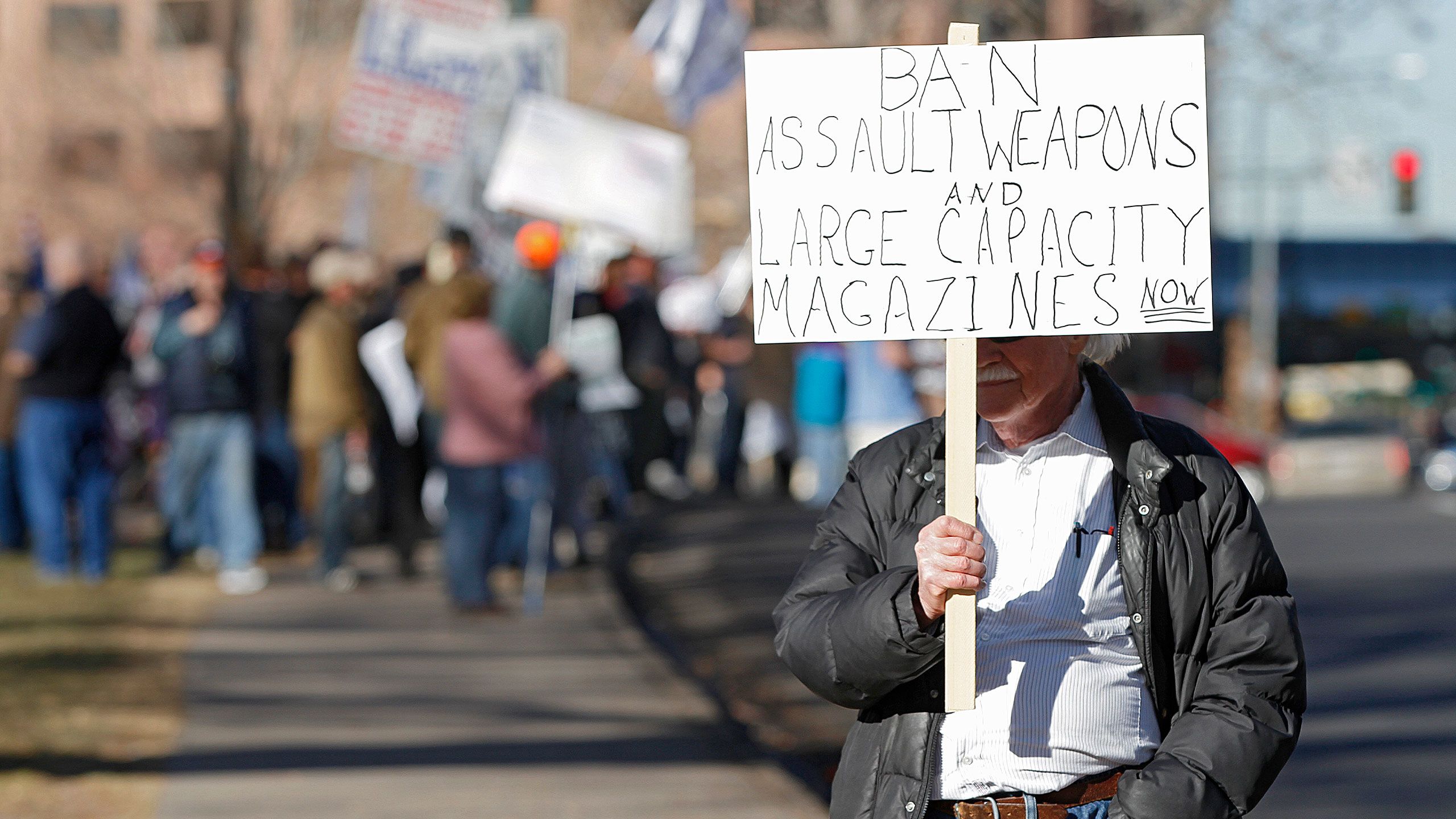 An image of an anti-gun activist protesting in Denver, Colorado