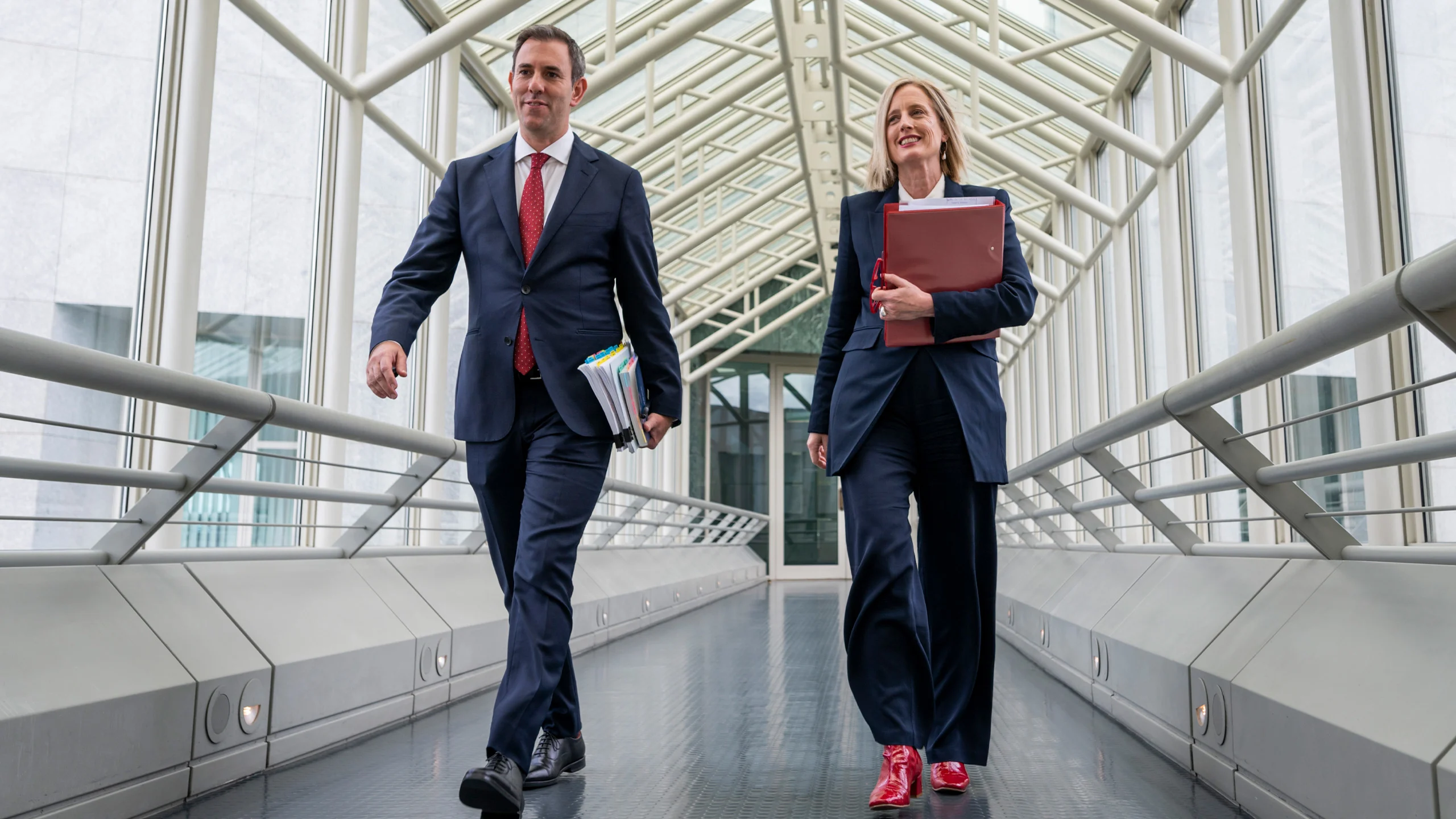 An image of Treasurer Jim Chalmers and Finance Minister Katy Gallagher arriving at Parliament House before delivering the Albanese government's first budget.