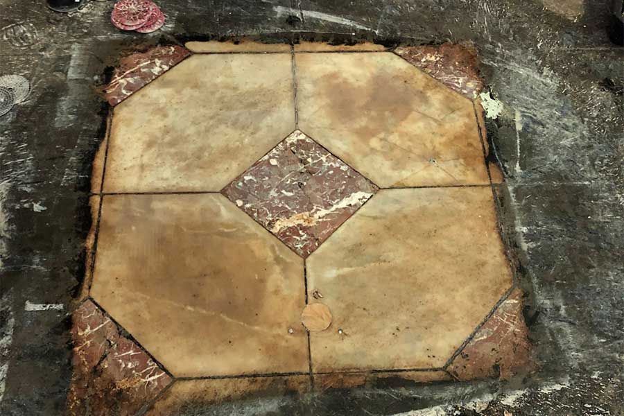 An image of the marble floor being worked restored. Image: Conrad Gargett