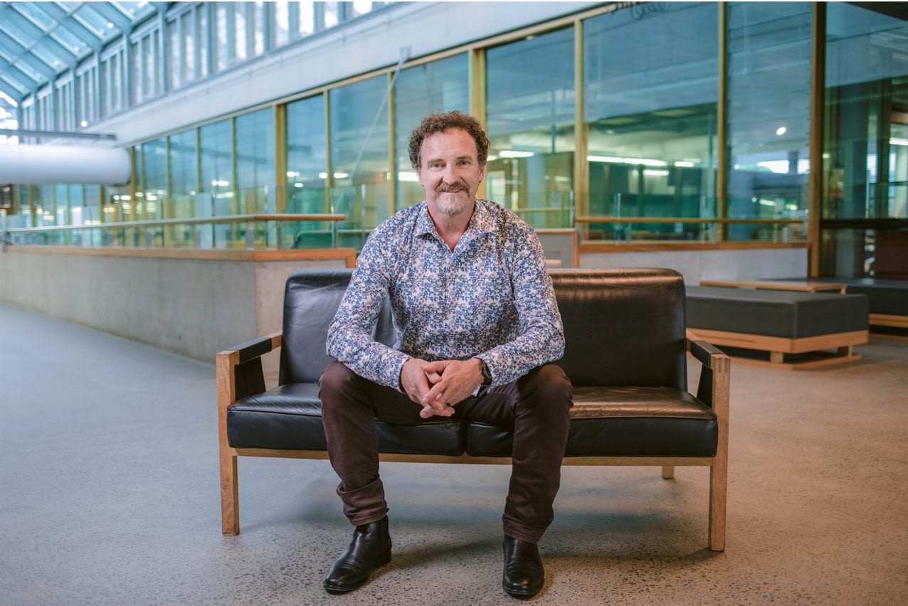 Professor Justin Cooper-White sitting on a sofa in the Hawken Engineering Building