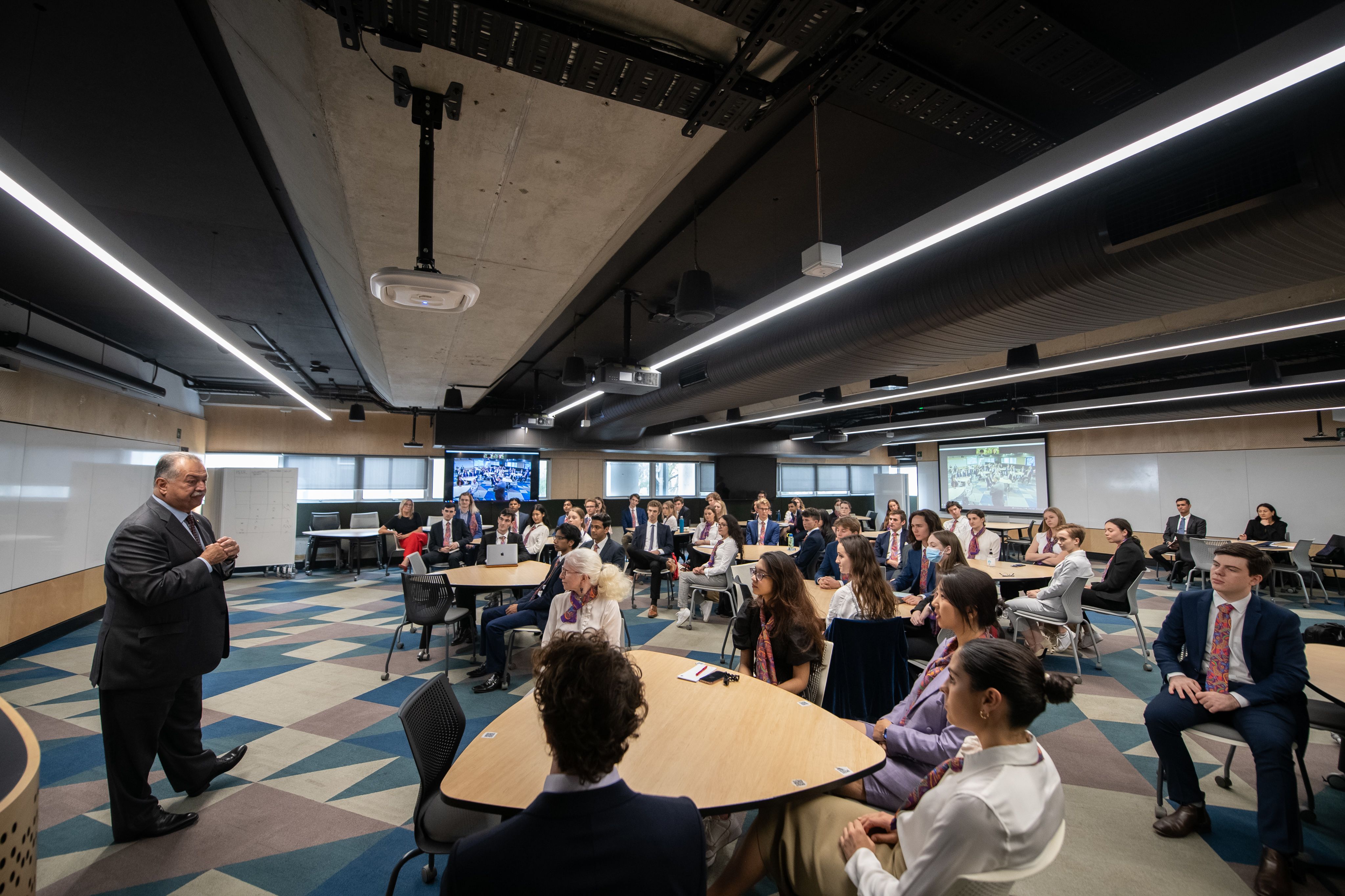 A lecture room of people listening to Andrew N. Liveris speak