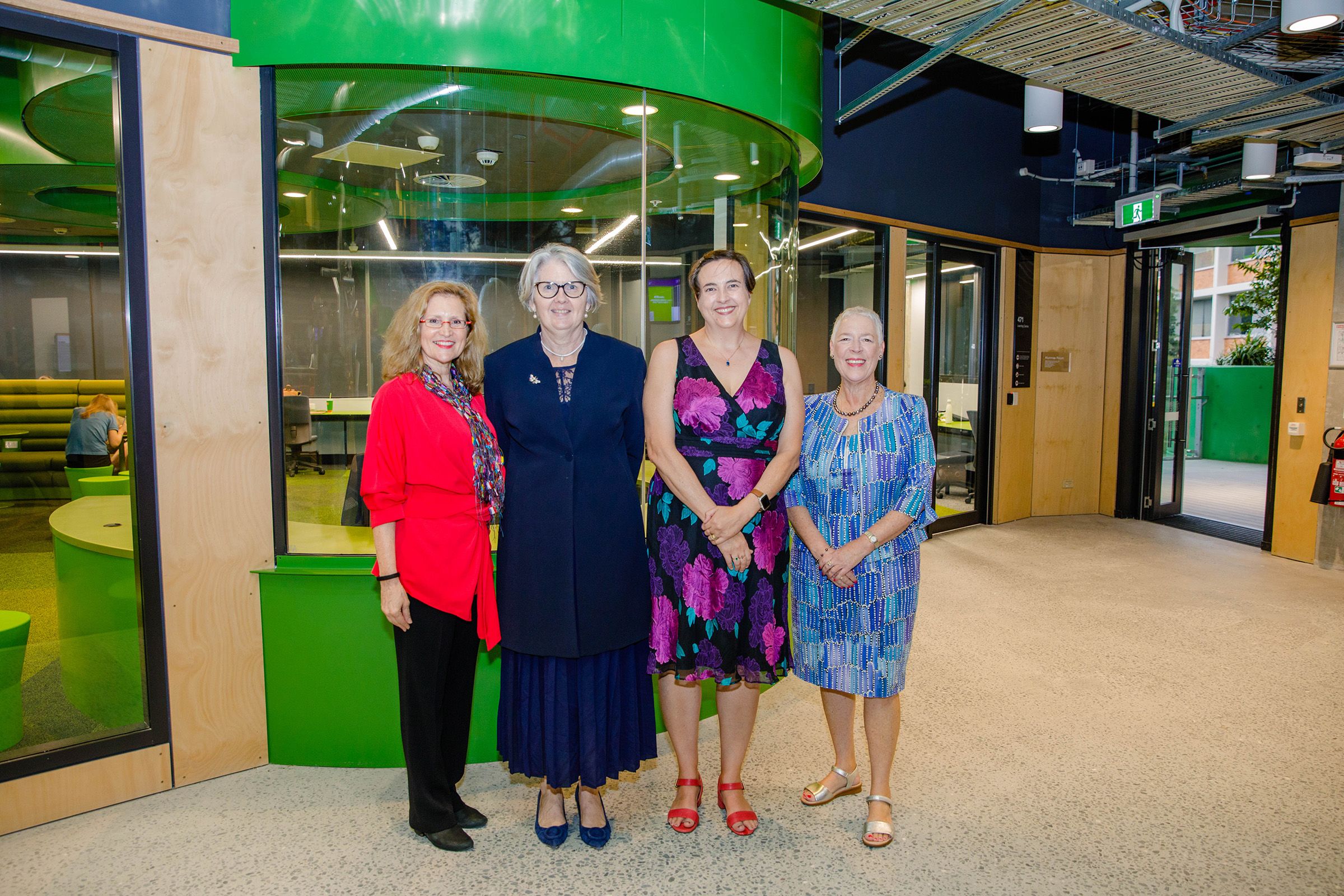 Four women standing together outside the Alumnae Room