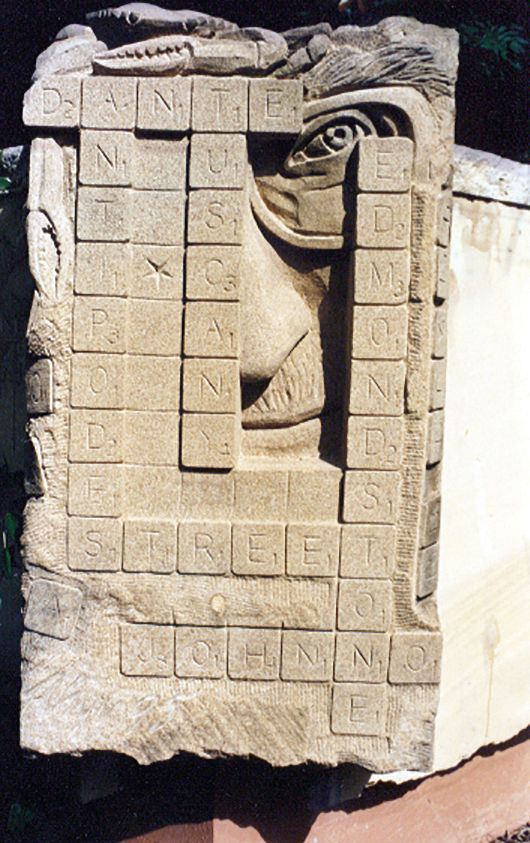 Carving of David Malouf and scrabble board