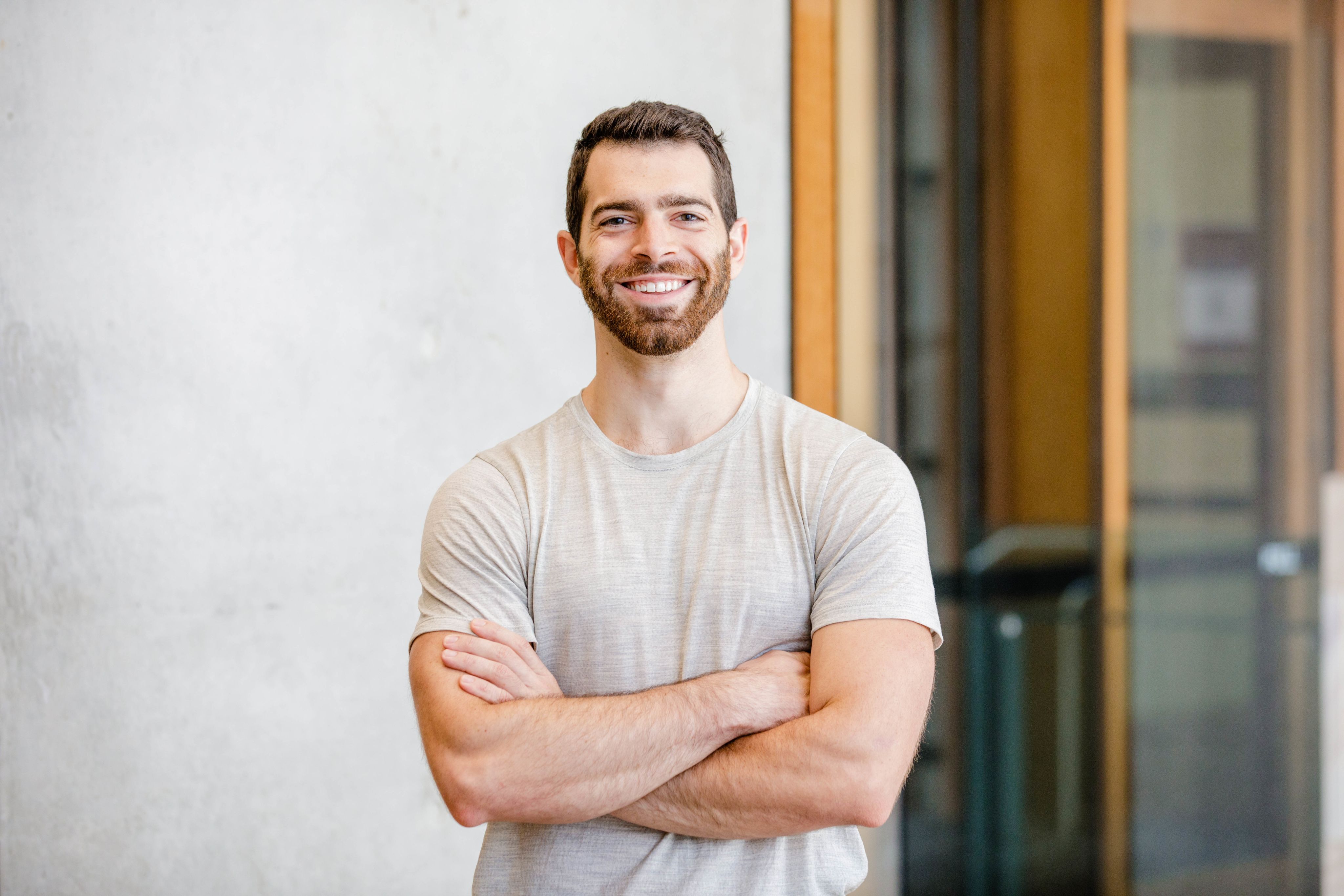 Lean Systems founder, Derek Scolnick, wears a grey t-shirt and is smiling at the camera.