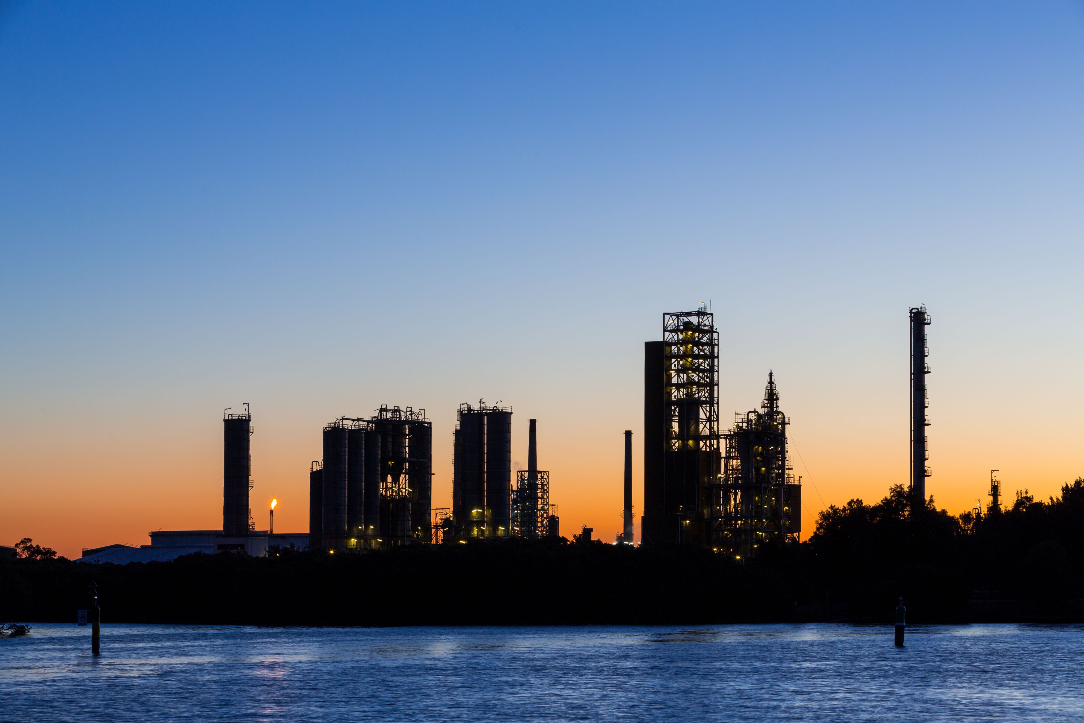 Silhouette at sunset on a clear sky of a petroleum processing plant.