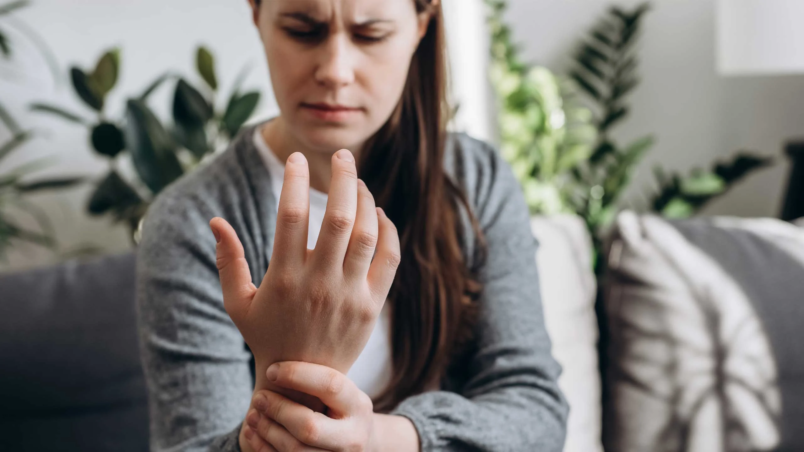 A lady massaging her wrist due to inflammation and pain.