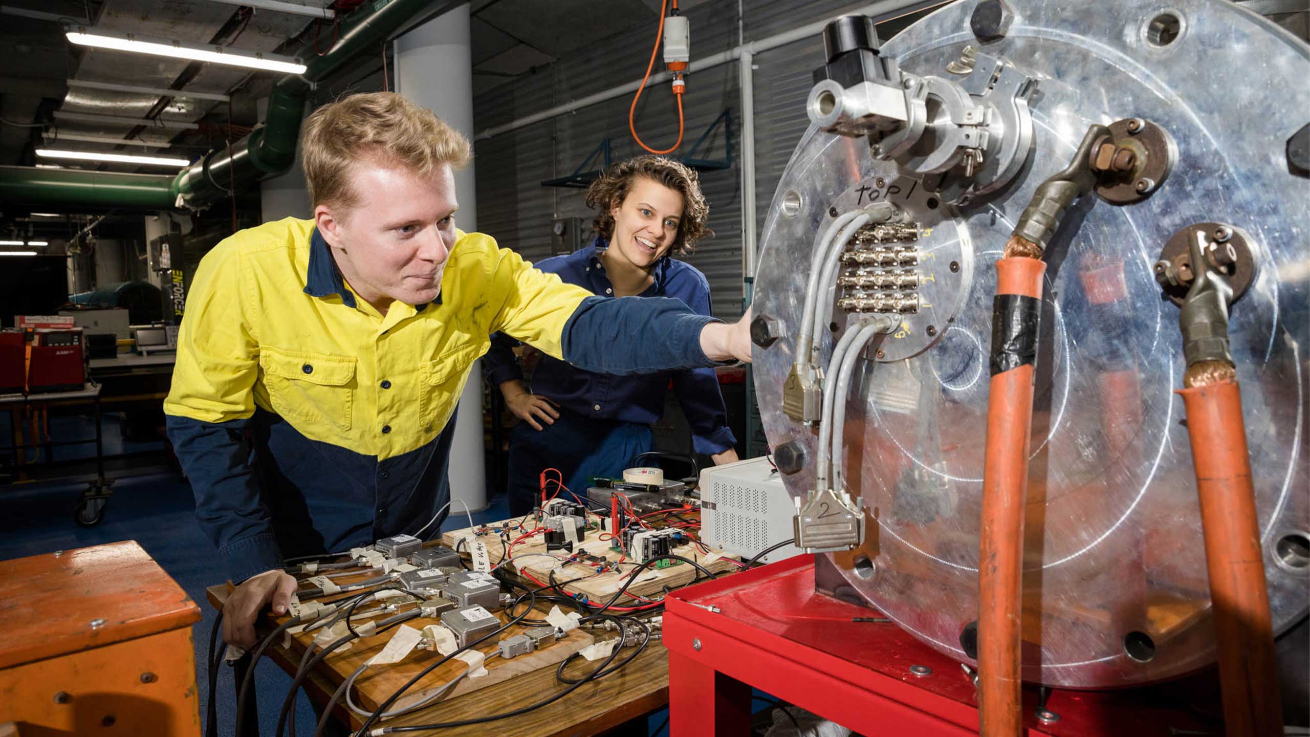 An image of Herik Labs founder Toby van den Herik and Simone Wilson inspecting equipment.