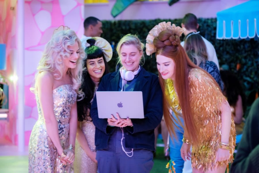 Greta Gerwig with actors in sparkling film costumes