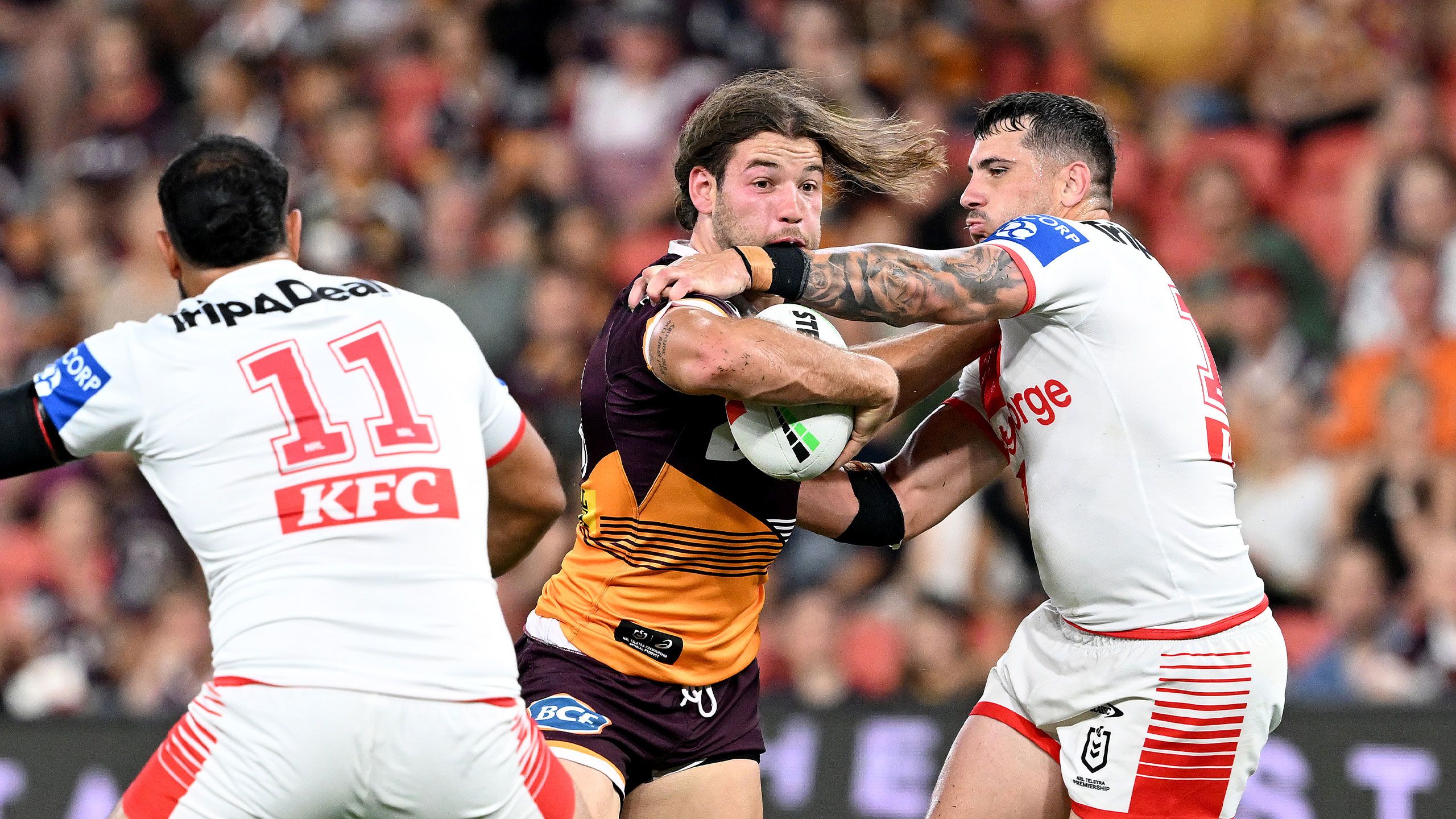 Pat Carrigan breaks through a tackle against the Dragons in round 2.