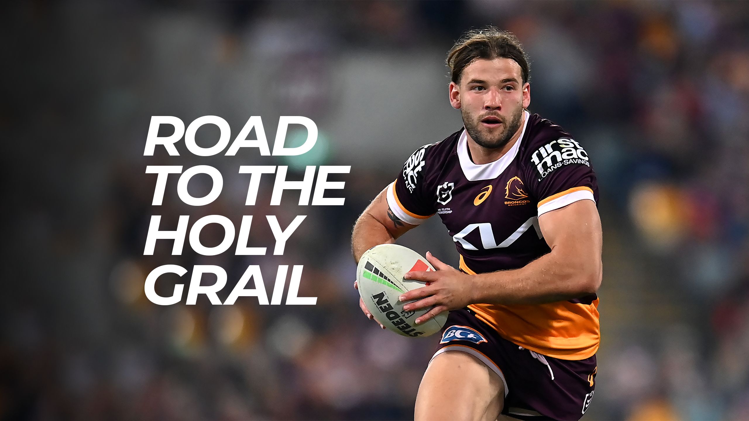 An image of Pat Carrigan running with the ball while playing for the Brisbane Broncos.
