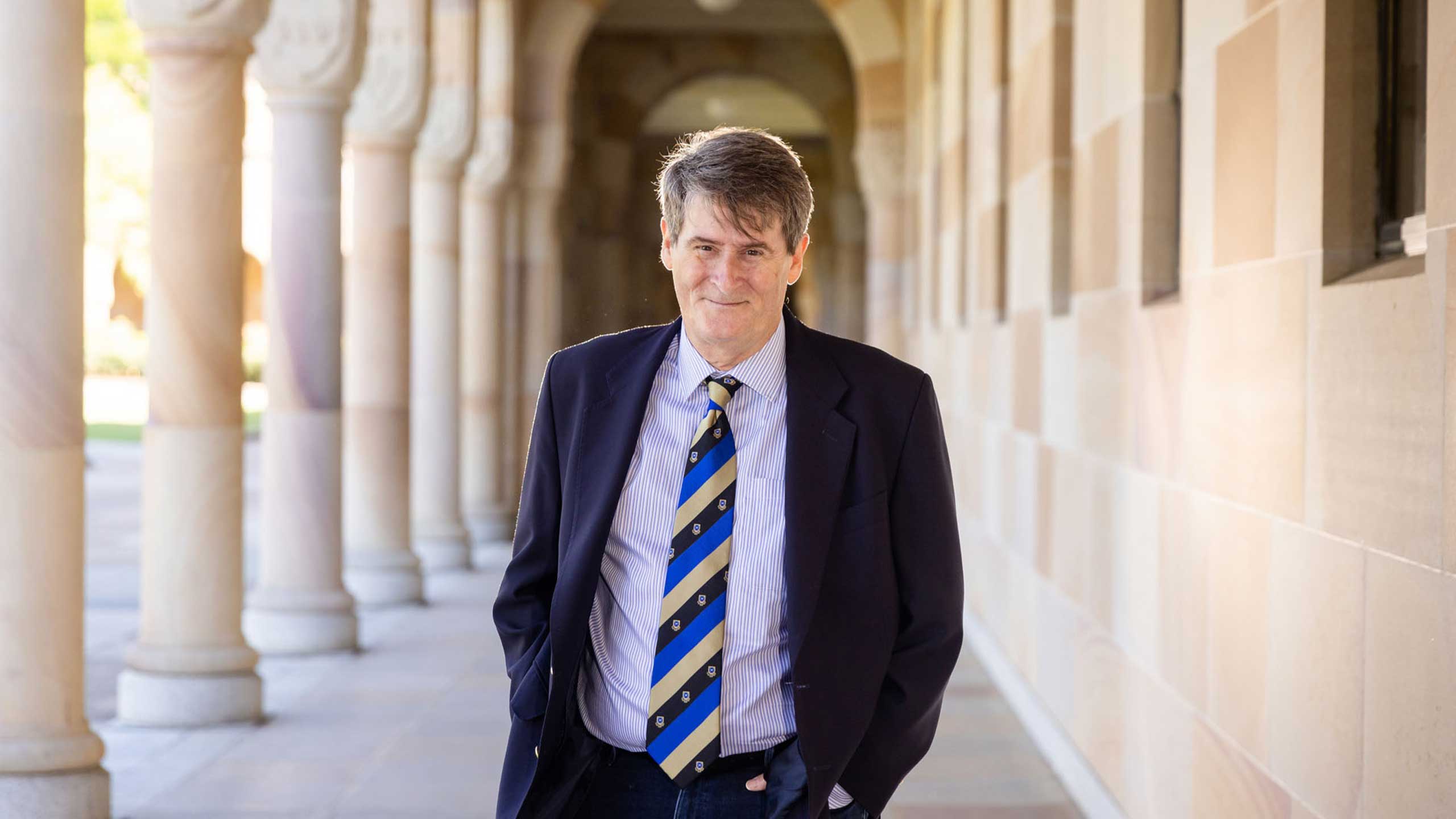 An image of Professor Victor Nurcombe among the cloisters of UQ's Great Court.