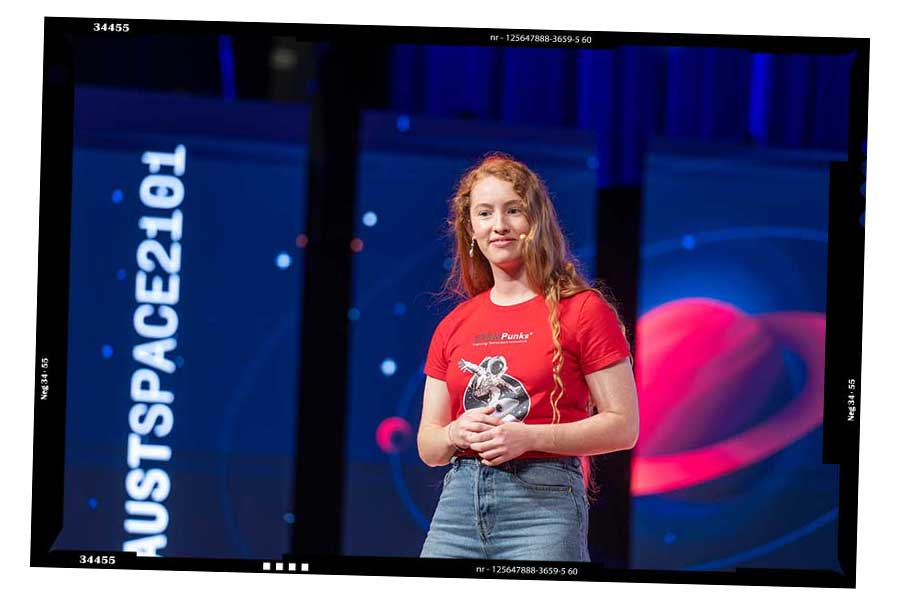 Emerald Gaydon on stage as MC at for the STEMPunks international SPACE2101 programs.