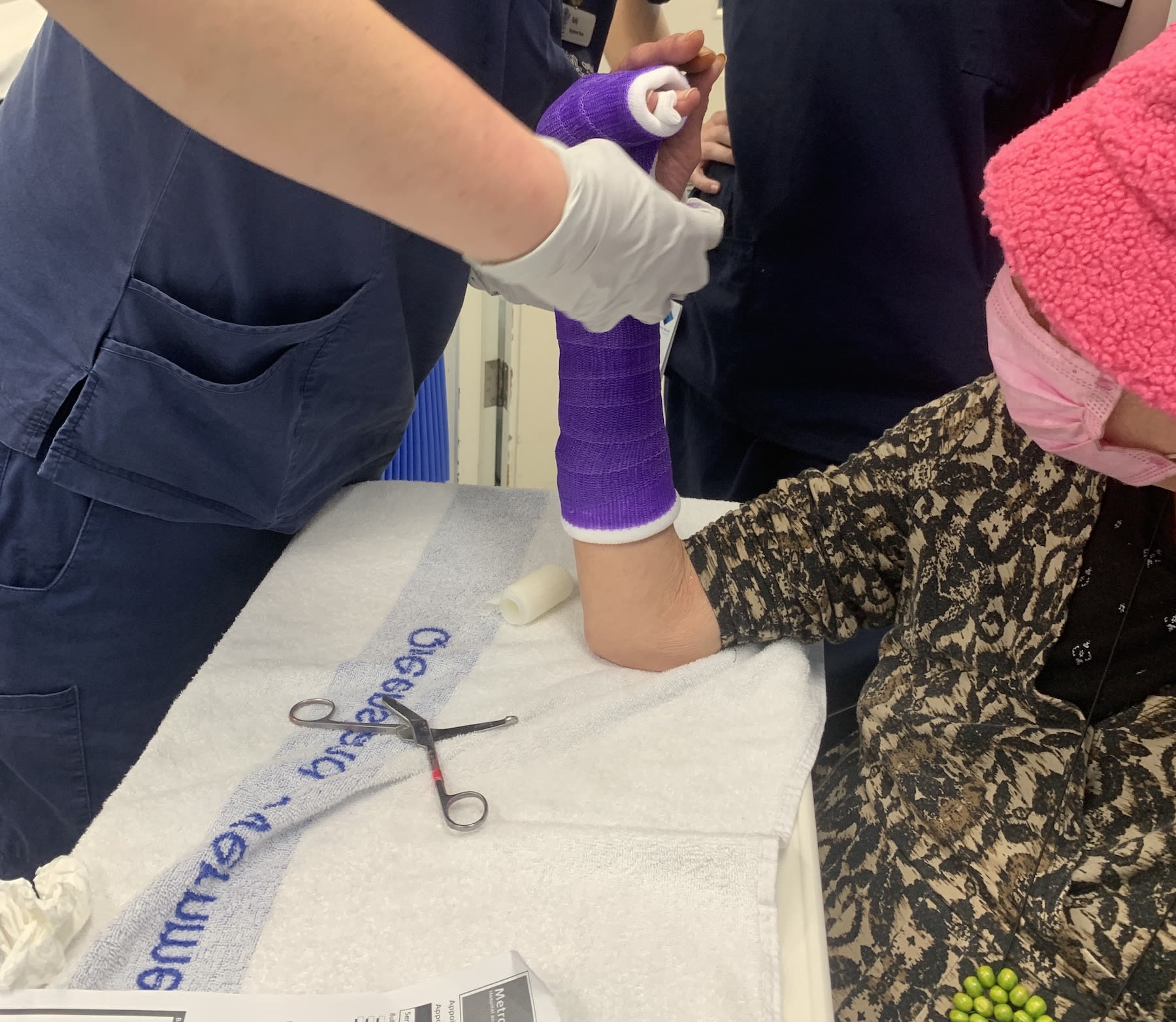 Woman in treatment room getting her arm plastered