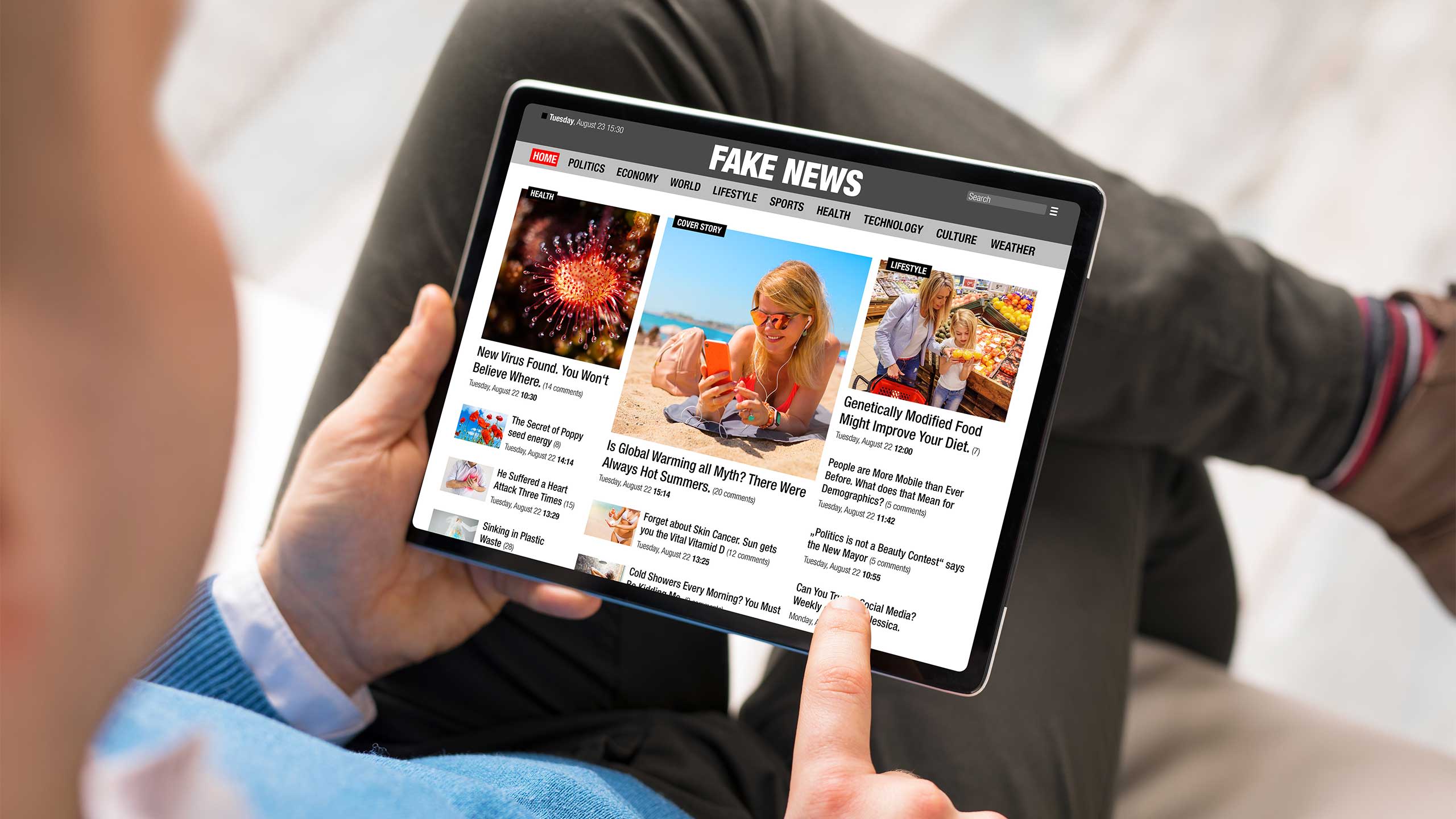 A man looking at an iPad showing fake news.