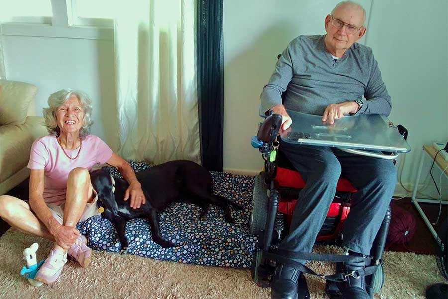 An image of Ann Copsey visiting her husband Jim with Marcie the Greyhound.