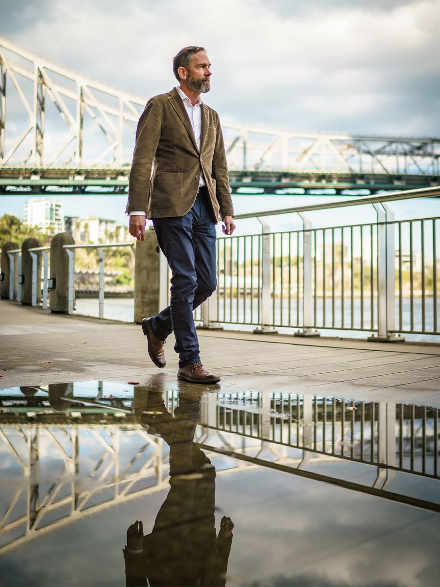 An image of An image of Dr Andrew Sneddon with Brisbane's Story Bridge in background.