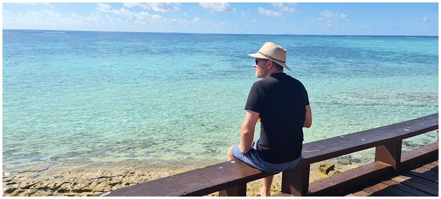 Chris Shaw sitting on the jetty looking at the ocean