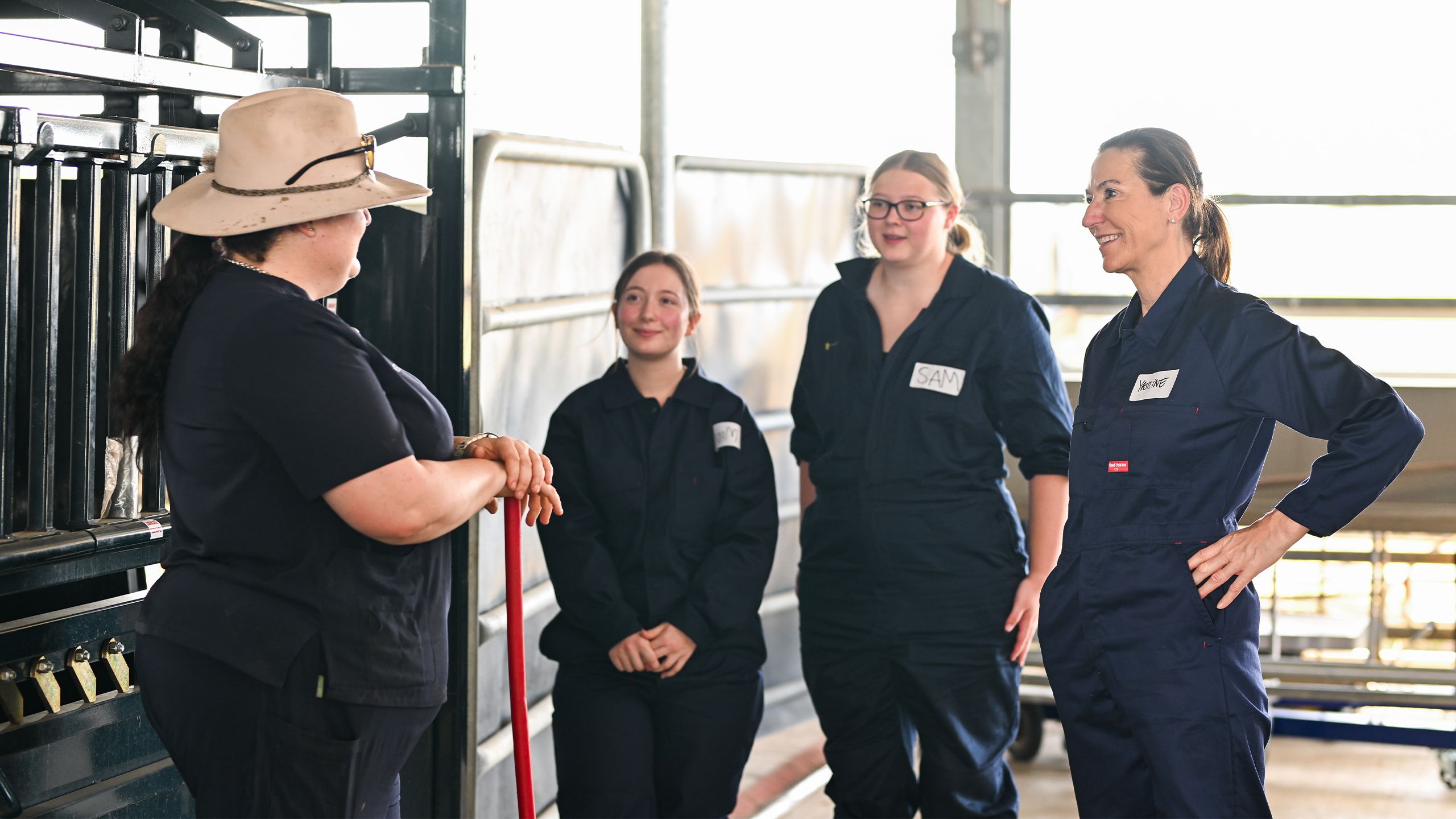 Yasmine Gray listening to instructions with other classmates before a practical class with cattle at UQ's Gatton campus.
