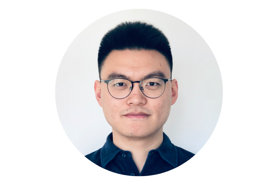 Photo of a man with dark hair, glasses, and a navy blue shirt