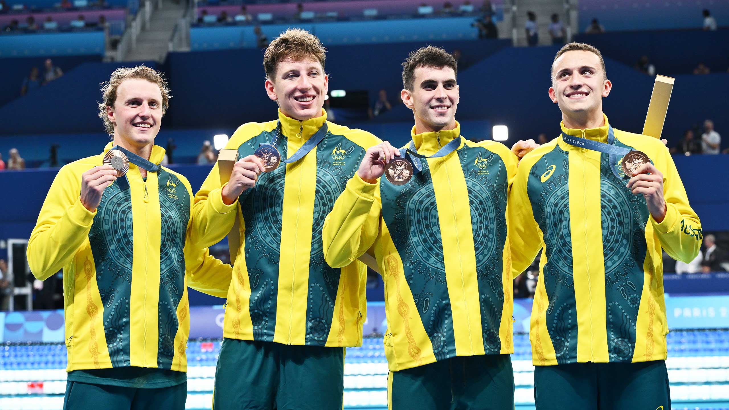 Elijah Winnington, Maximillian Giuliani, UQ student Thomas Neill (second from right) and Flynn Southam with their bronze medals after the men's 4x200 metres freestyle relay final.