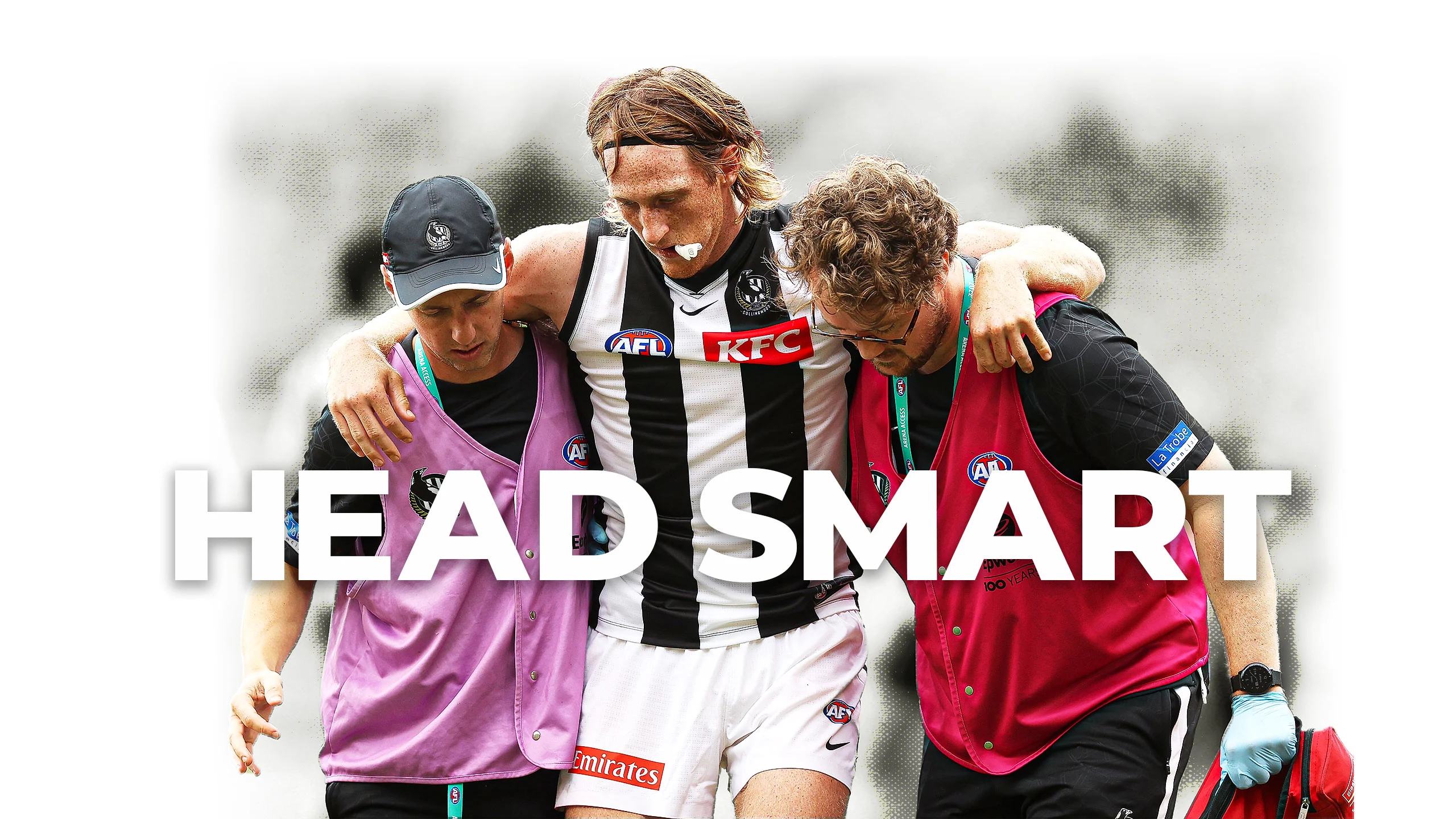 Head smart: Collingwood defender Nathan Murphy is helped from field after suffering concussion.