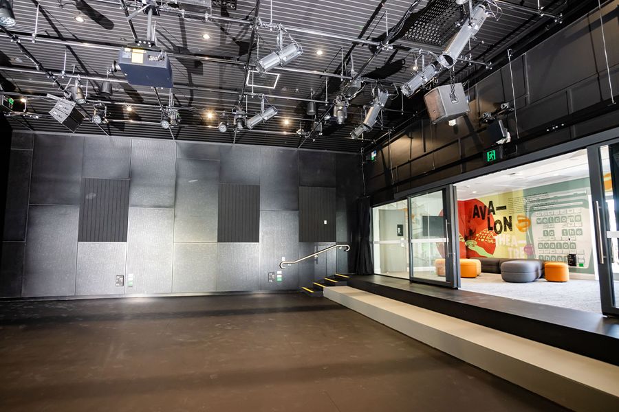 The inside of the smaller performance space with stage lighting and seating.