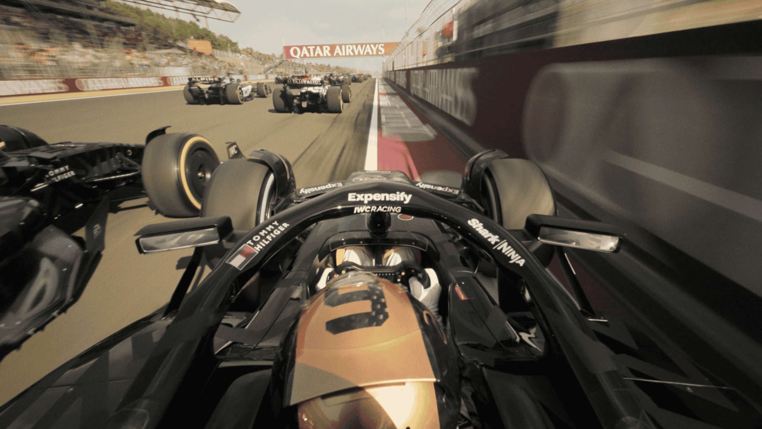 A point-of-view of a Formula 1 race car driver racing on the circuit.