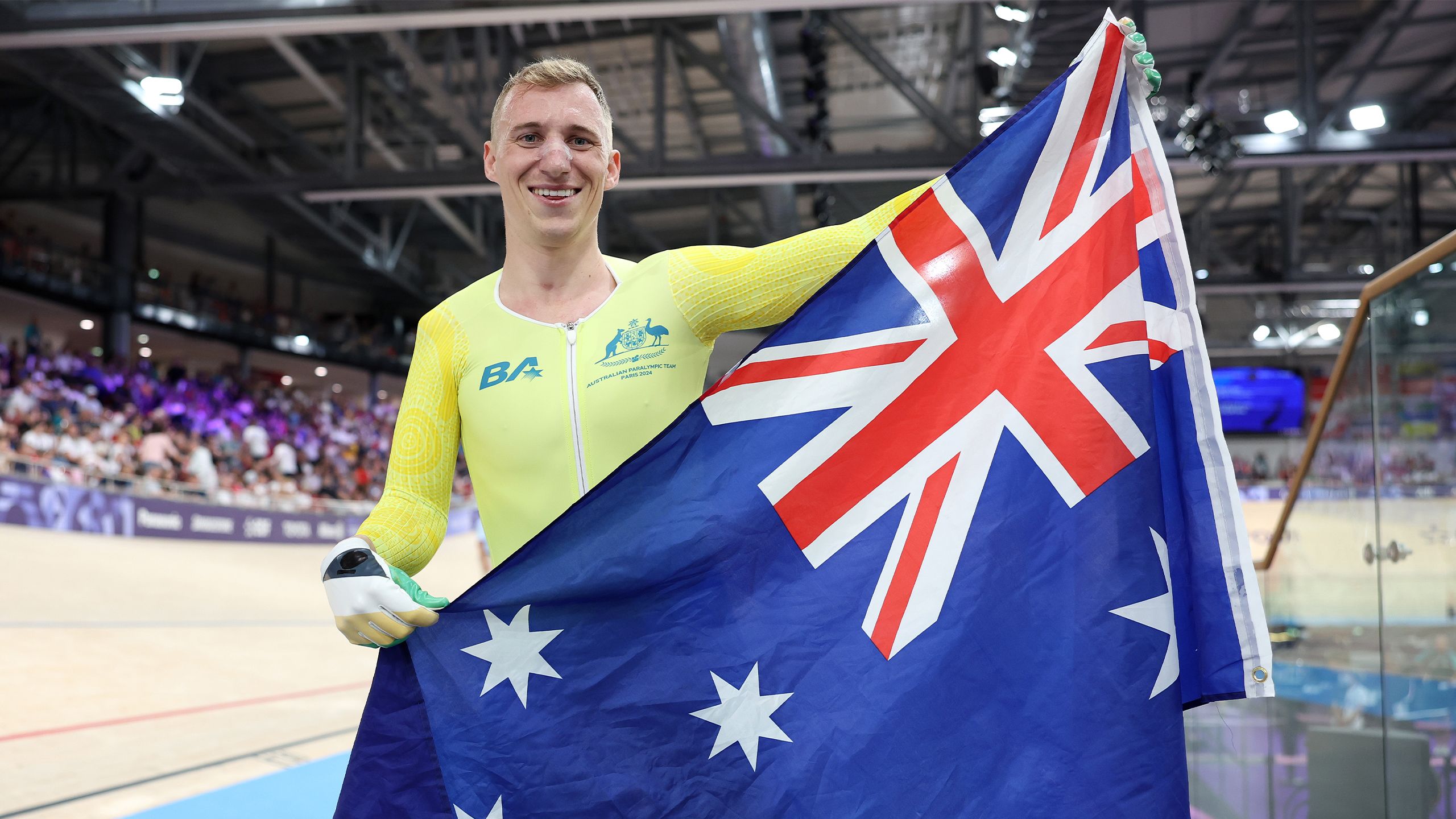 Gold medalist Korey Boddington celebrates with the Australian flag after claiming gold in his Paralympic debut in Paris. Image: Michael Steele/Getty Images