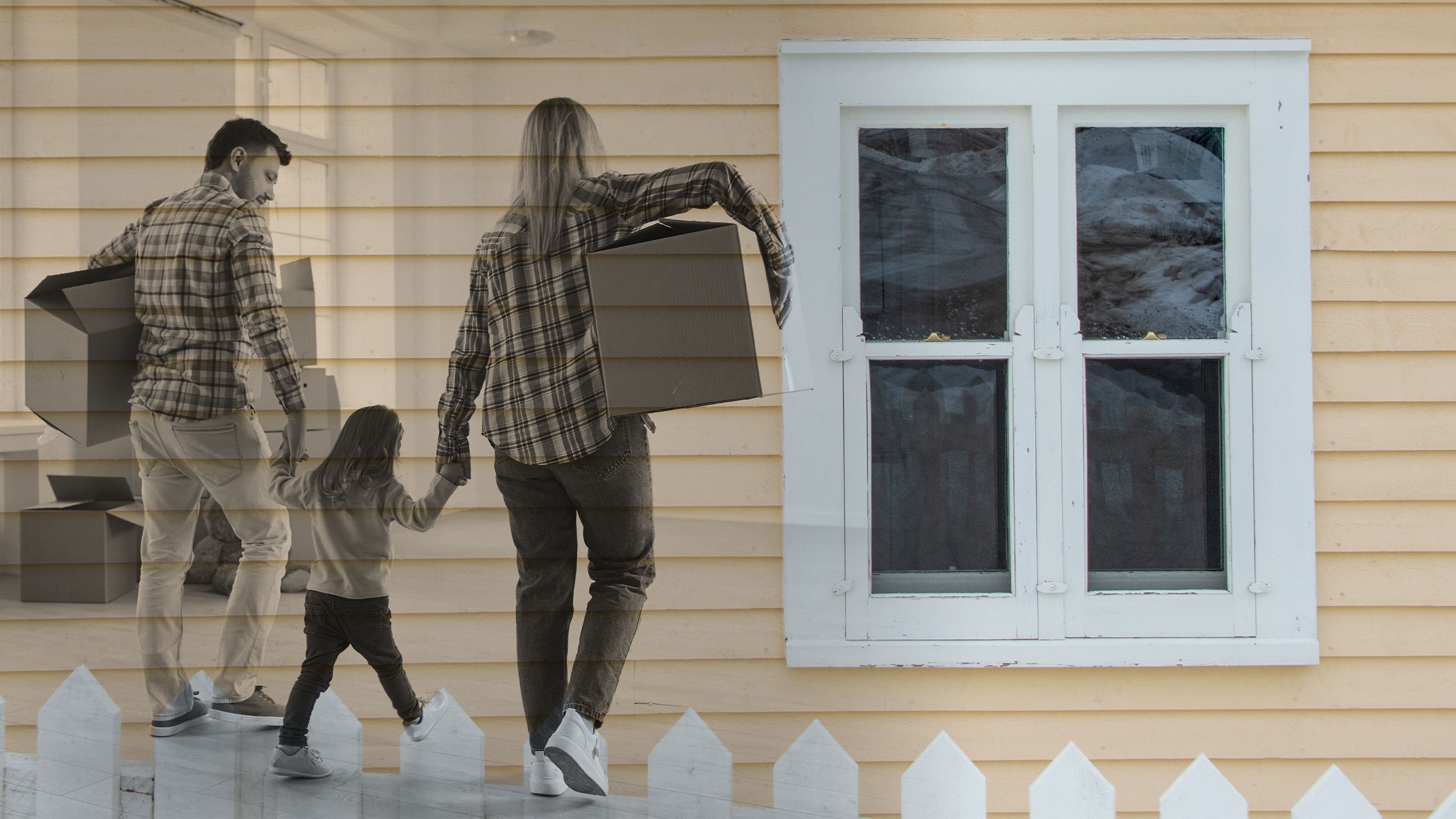 Mother and father with a child moving boxes in a new apartment or house.