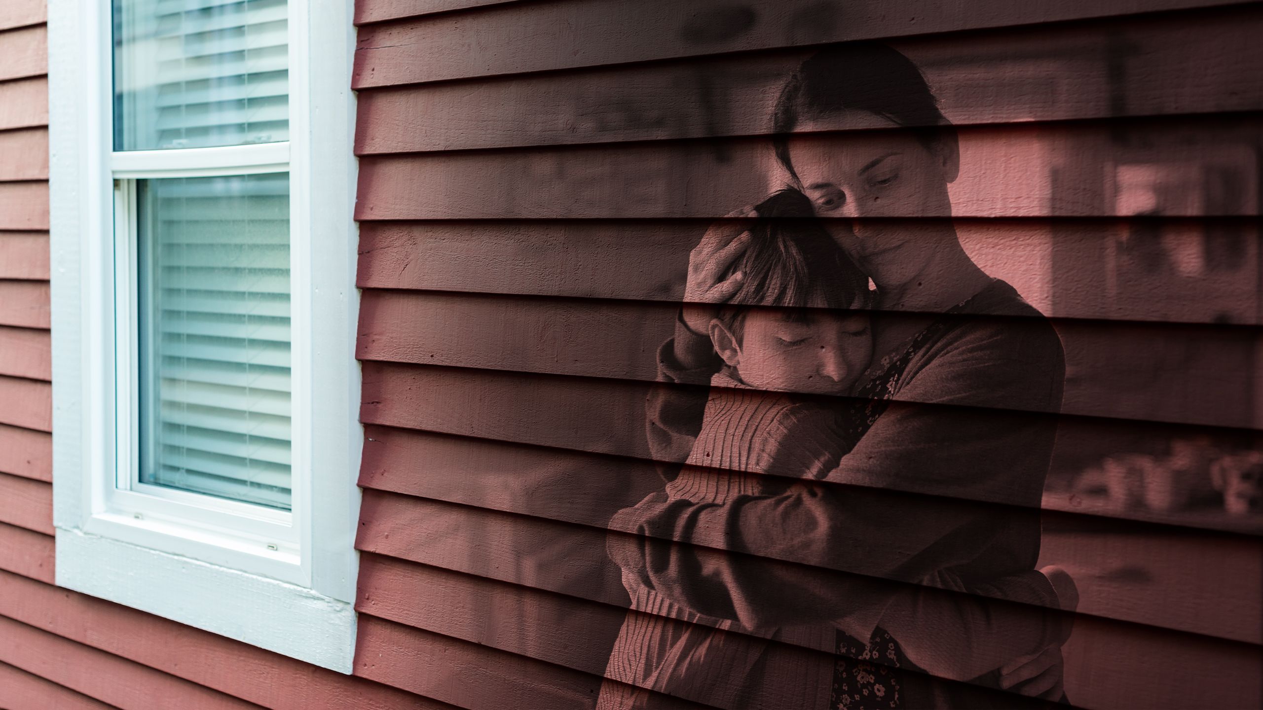 Portrait of mother hugging small daughter indoors at home, housing-crisis concept.