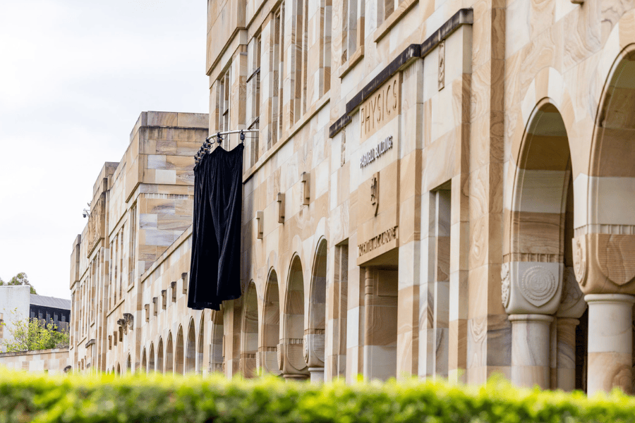 A wide shot of the Great Court cloisters with the final grotesque hidden by a black veil before the official unveiling.