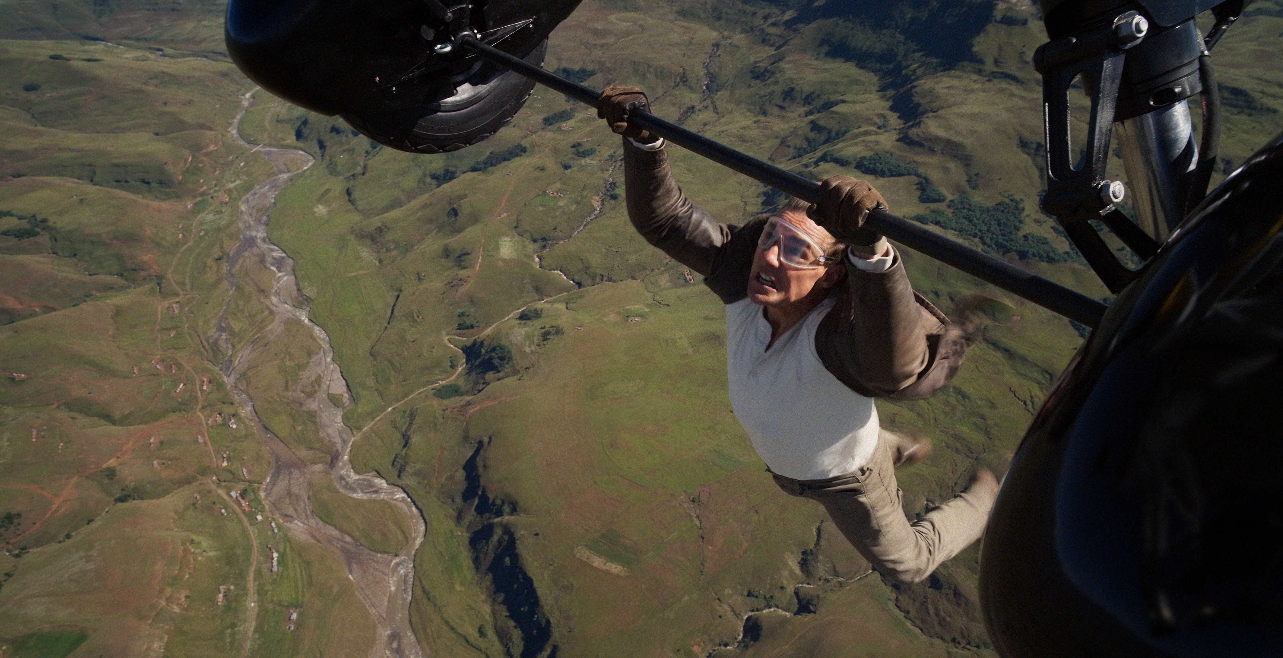 A scene from Mission: Impossible where Ethan Hunt (Tom Cruise) hangs off a plane