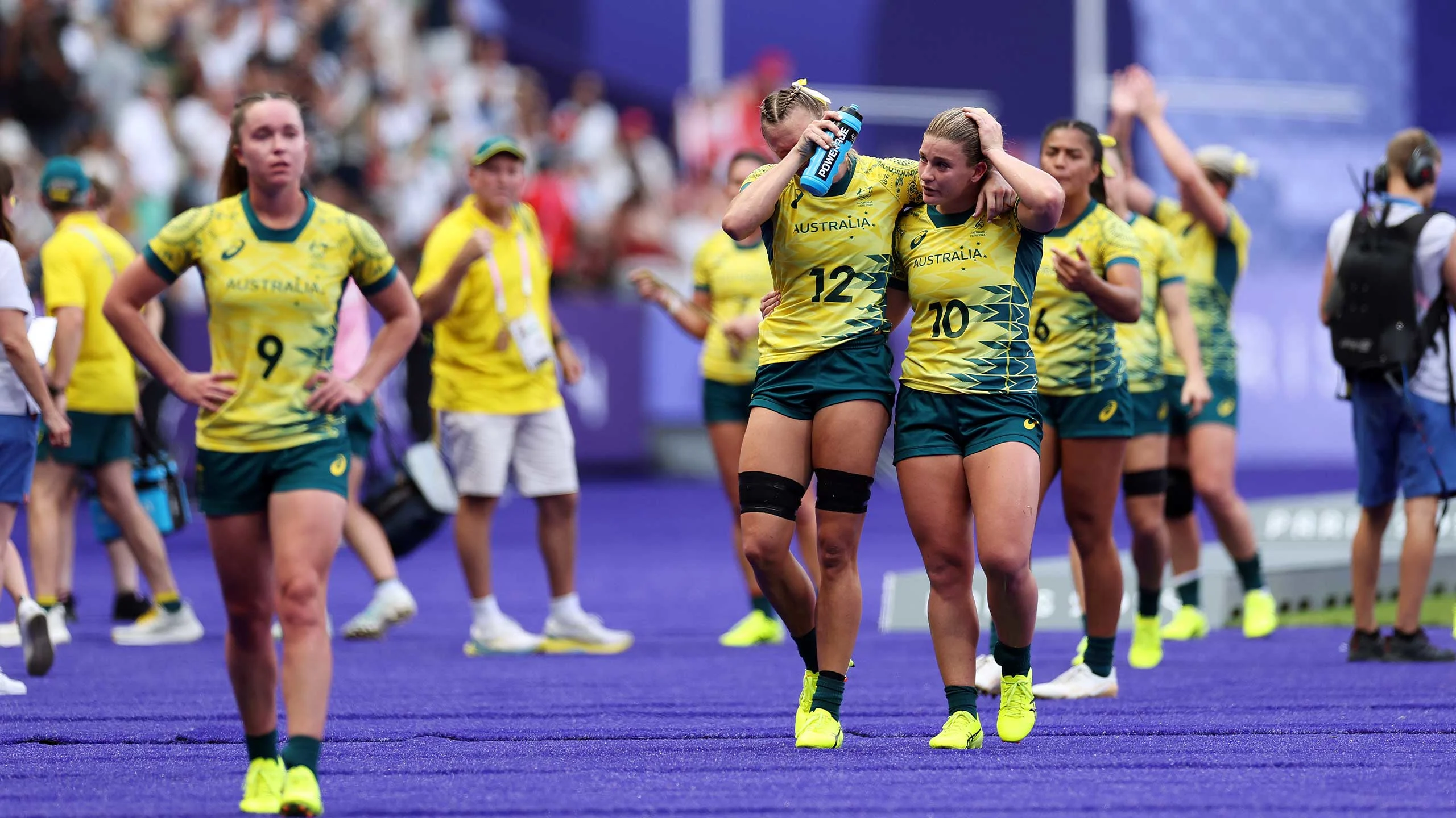 Maddison Levi (number 12) and UQ student Bella Nasser (number 10) console each other their loss to Canada in the women's rugby sevens semi-final. Image: Cameron Spencer/Getty Images