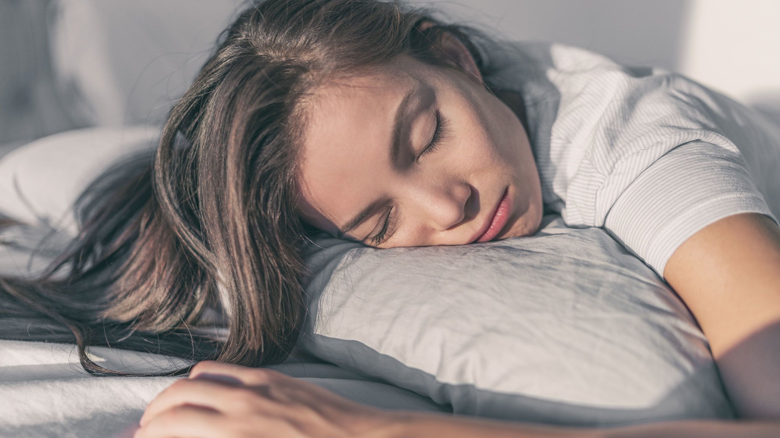 Woman sleeping on the side of her face.