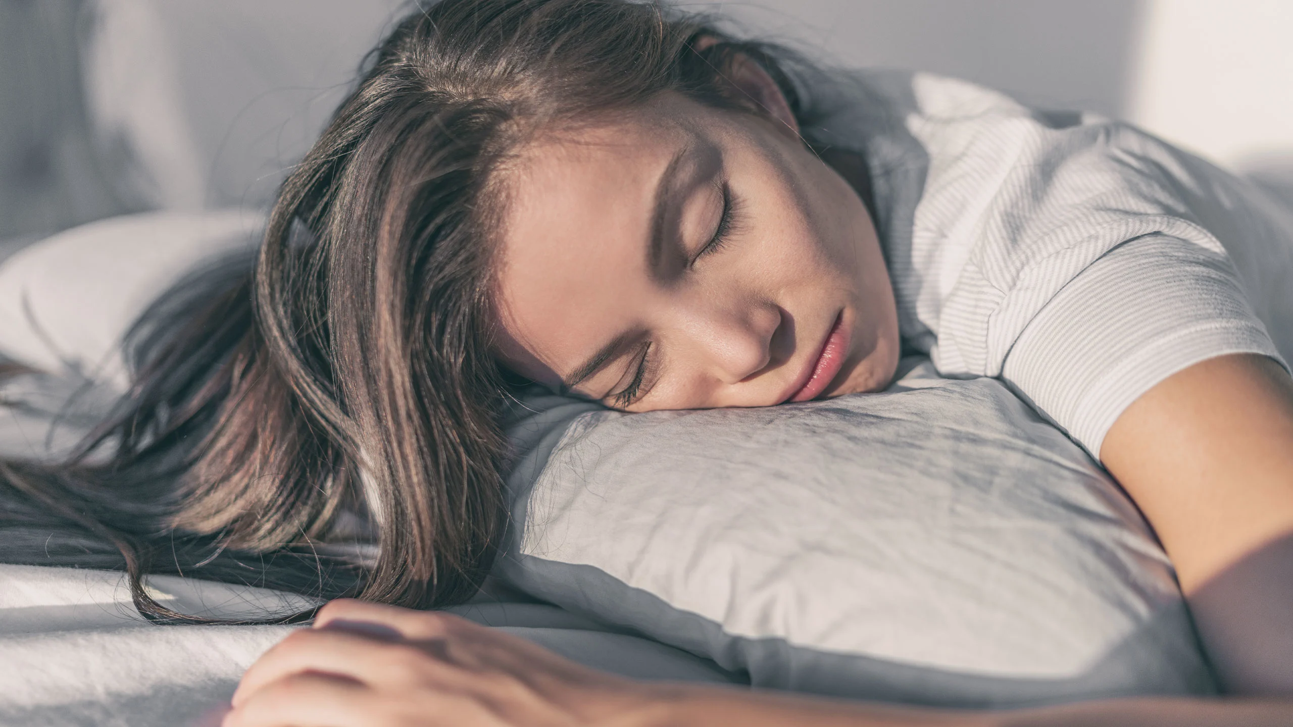 Woman sleeping on the side of her face.