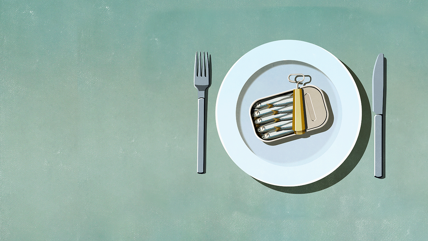 AN illustration of an open tin of sardines on a dinner plate with a knife and fork either side.