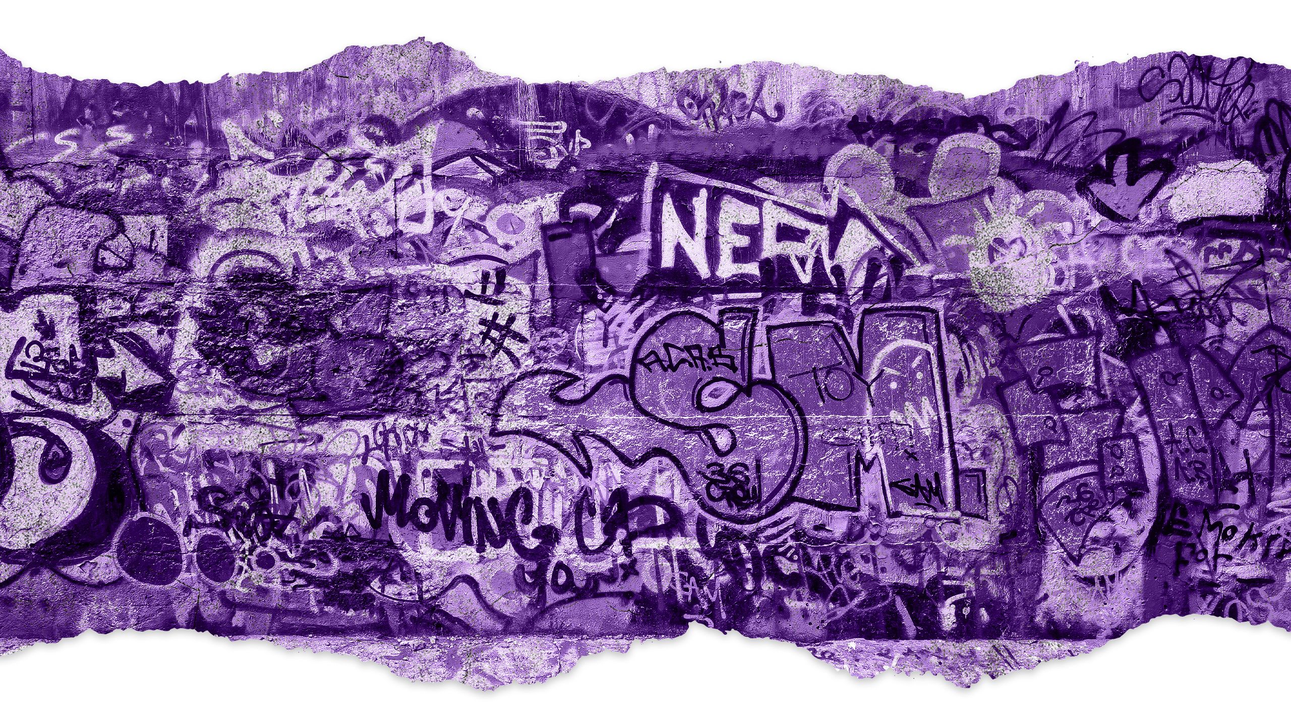 A gritty urban wall covered in graffiti.