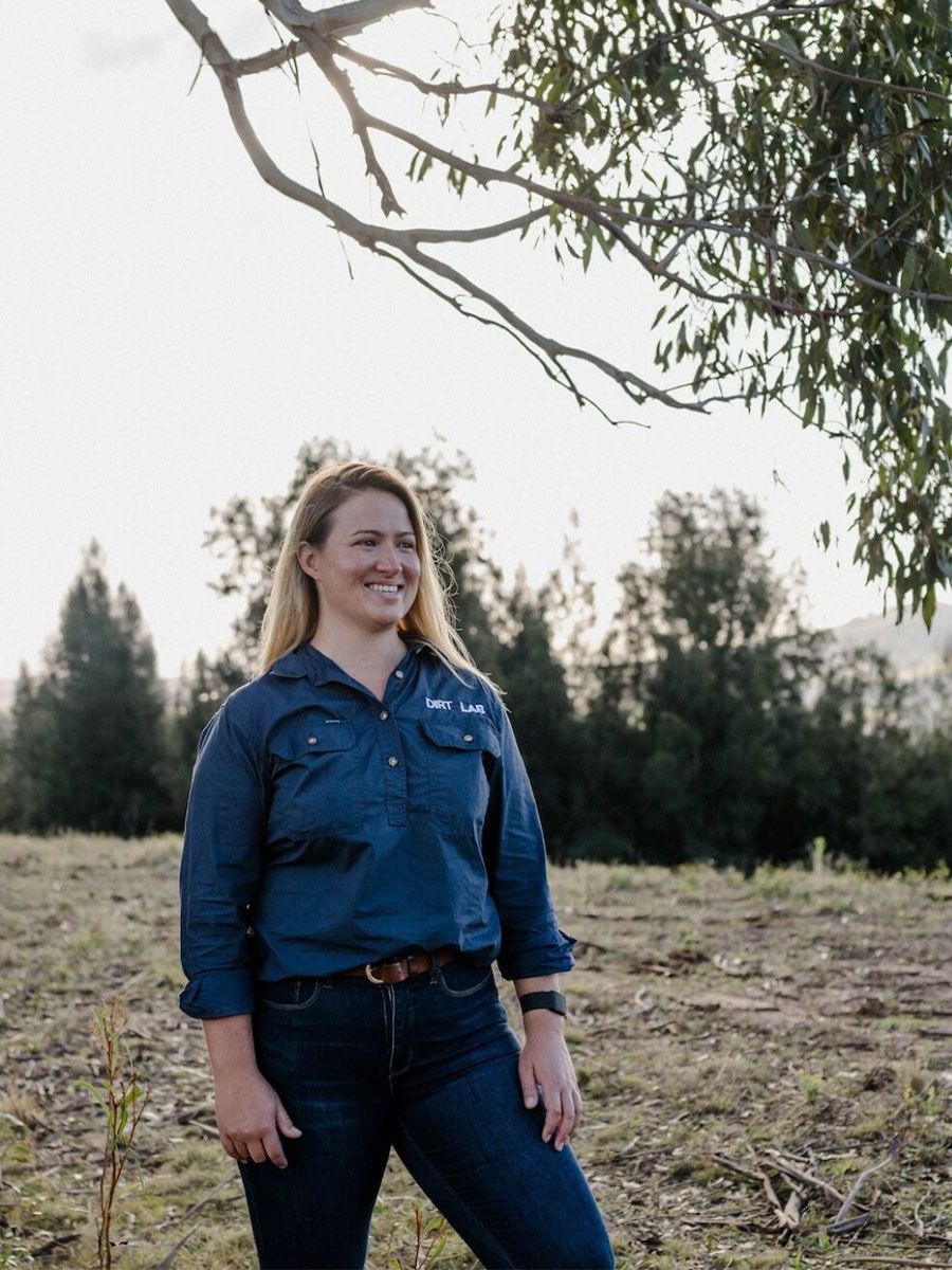 Jess Pattison wearing a Dirt Lab shirt and standing in a paddock.