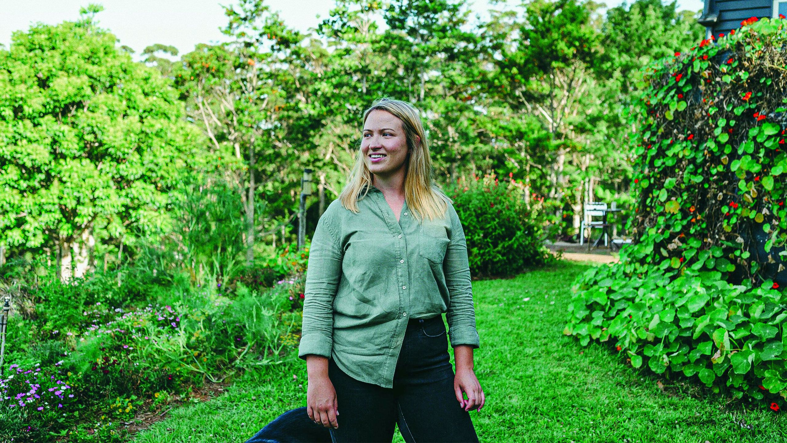 Jess Pattison standing in a rural garden.