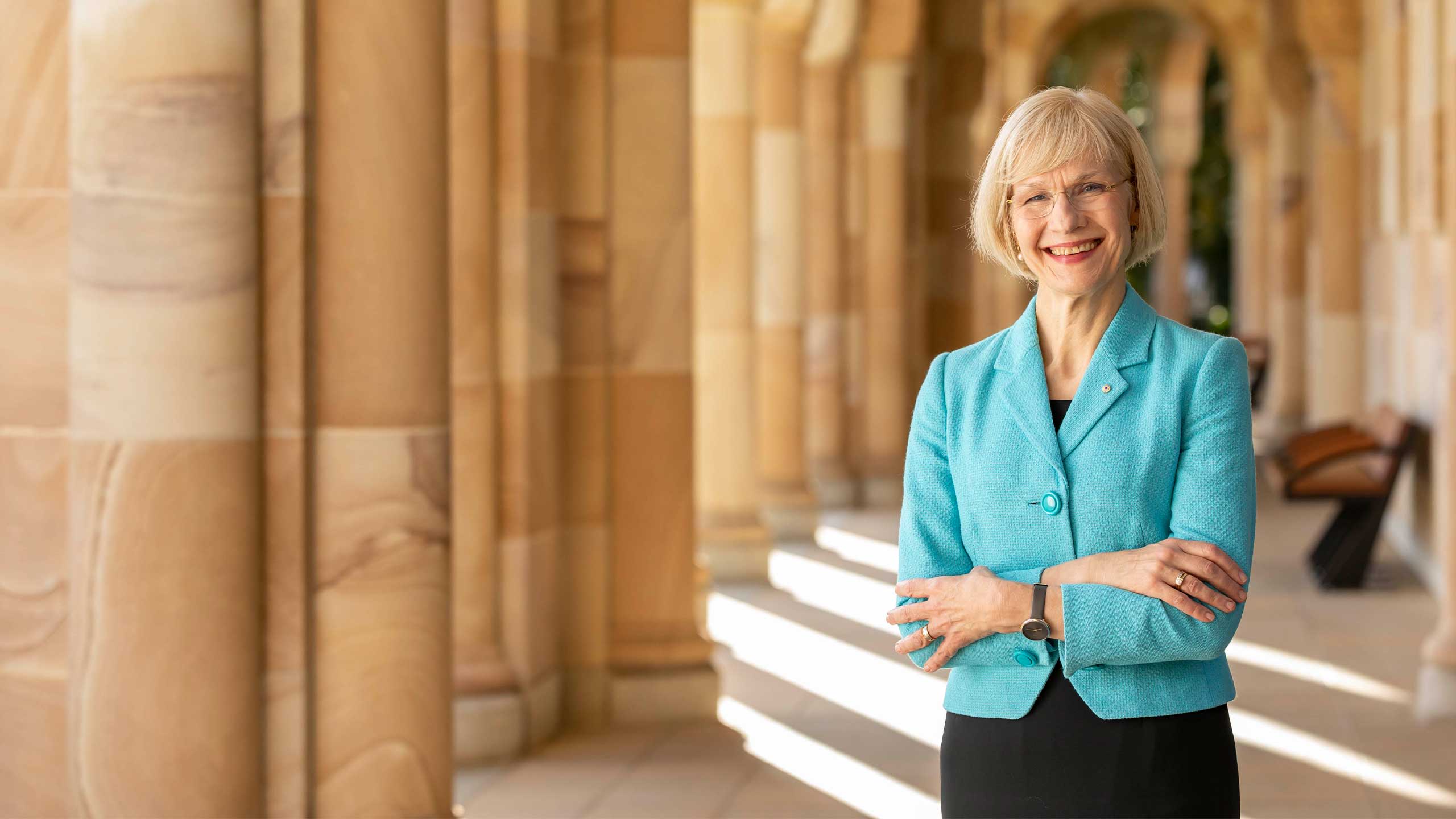 An image of UQ Vice-Chancellor and President Professor Deborah Terry AC among the cloisters in the Great Court.