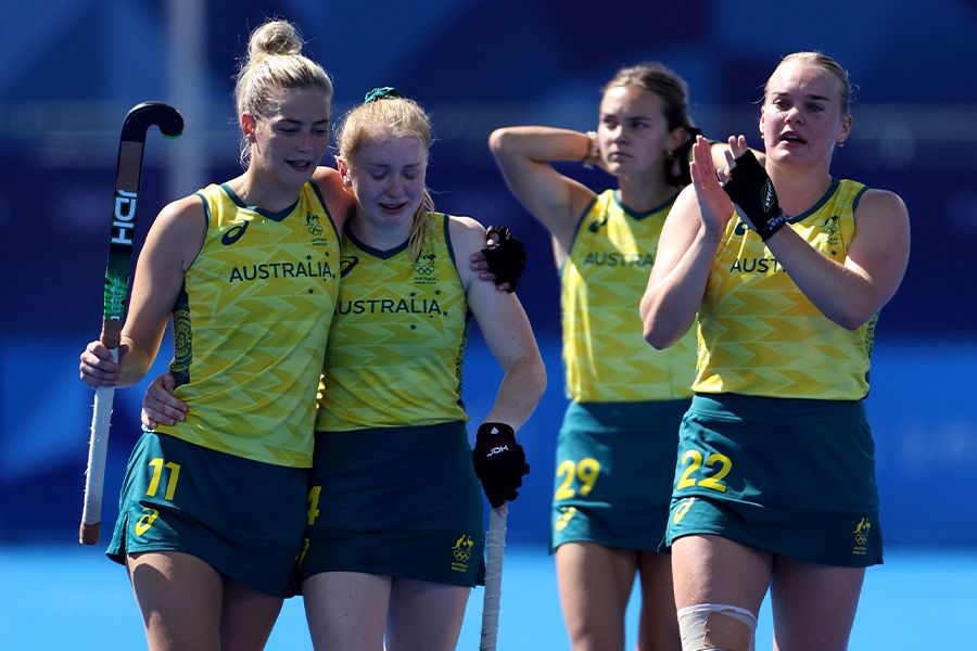 Alice Arnott, Amy Lawton, UQ alum Rebecca Greiner and UQ student Tatum Stewart after Australia's loss to China on Monday. Image: Luke Hales/Getty Images