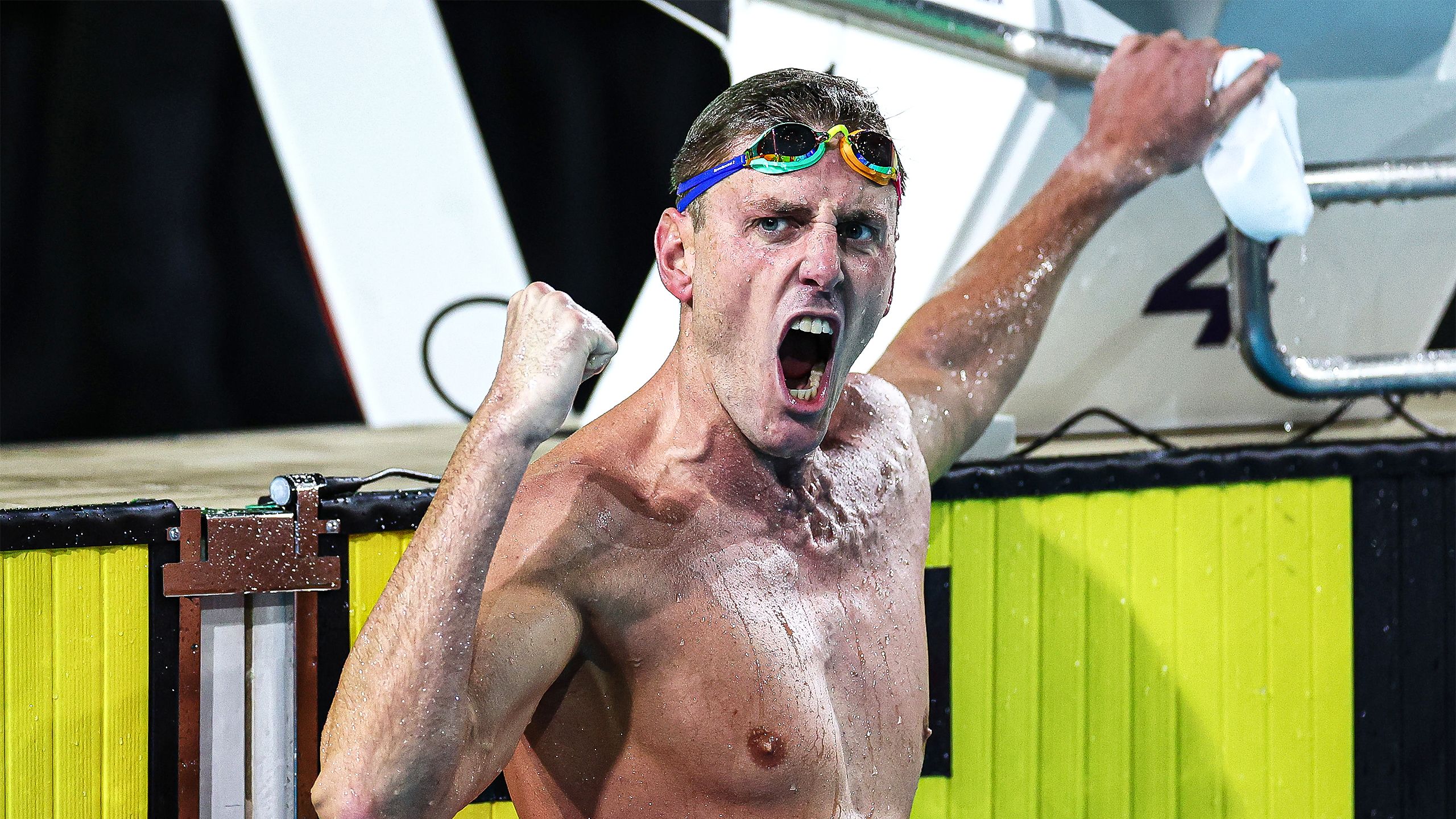 Brenden Hall celebrating in a pool after a swimming race.