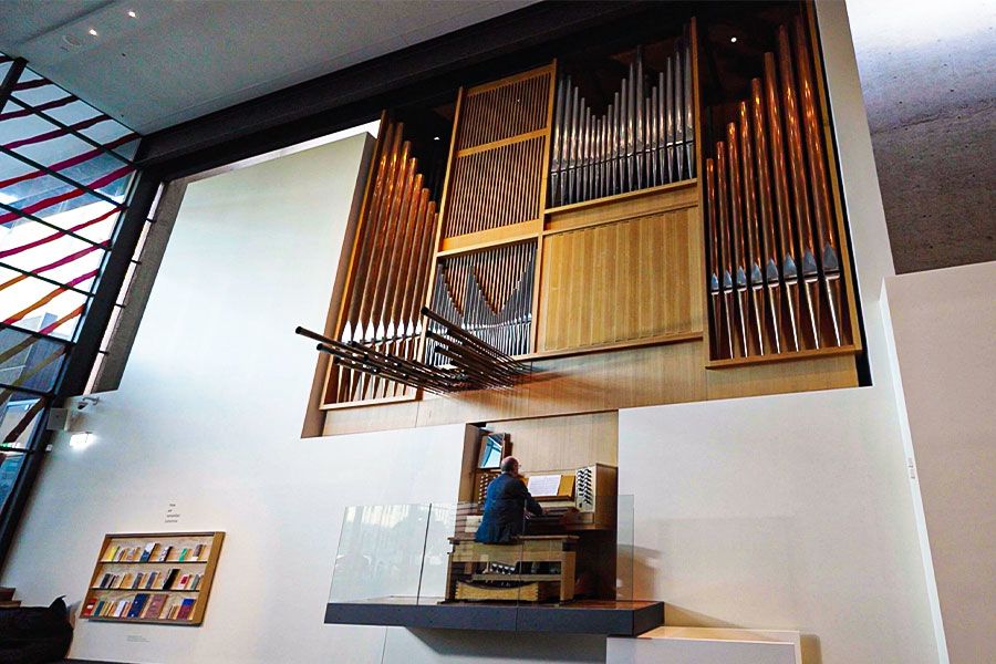 Dr Graeme Morton from UQ's School of music playing the pipe organ inside the UQ Art Museum.
