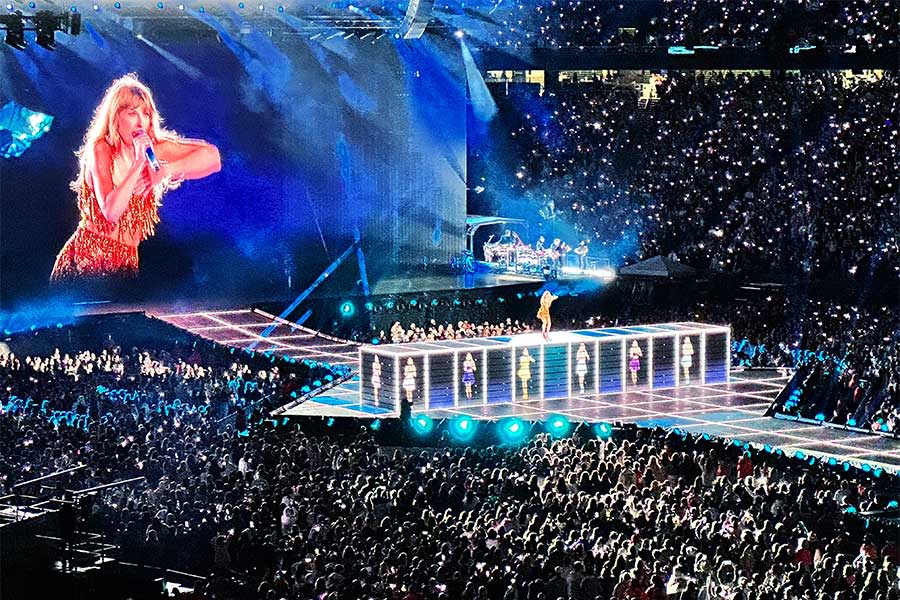 An image of Taylor Swift performing in front of a huge crowd.